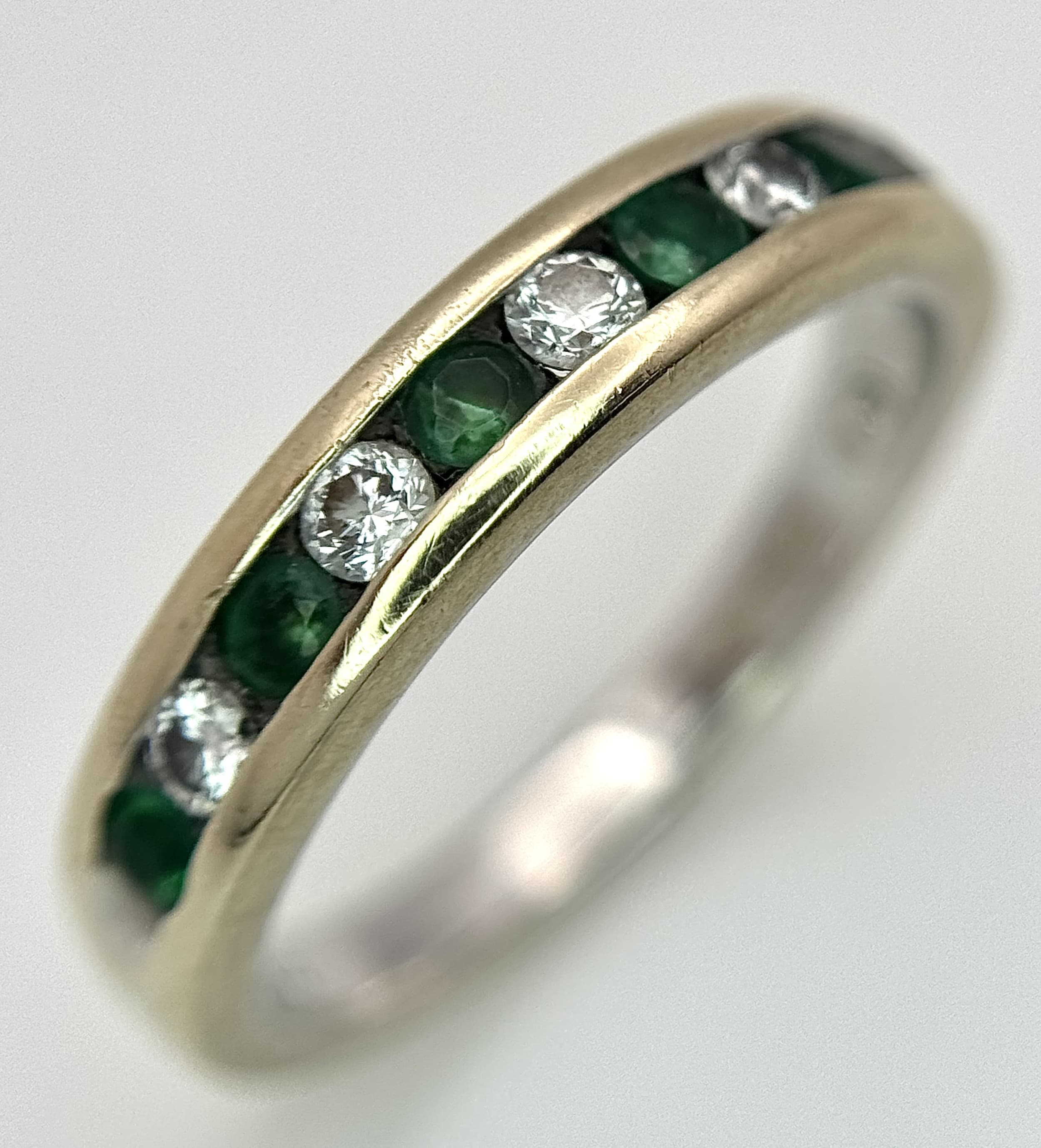 A Ladies 18K White Gold Diamond and Emerald Ring.