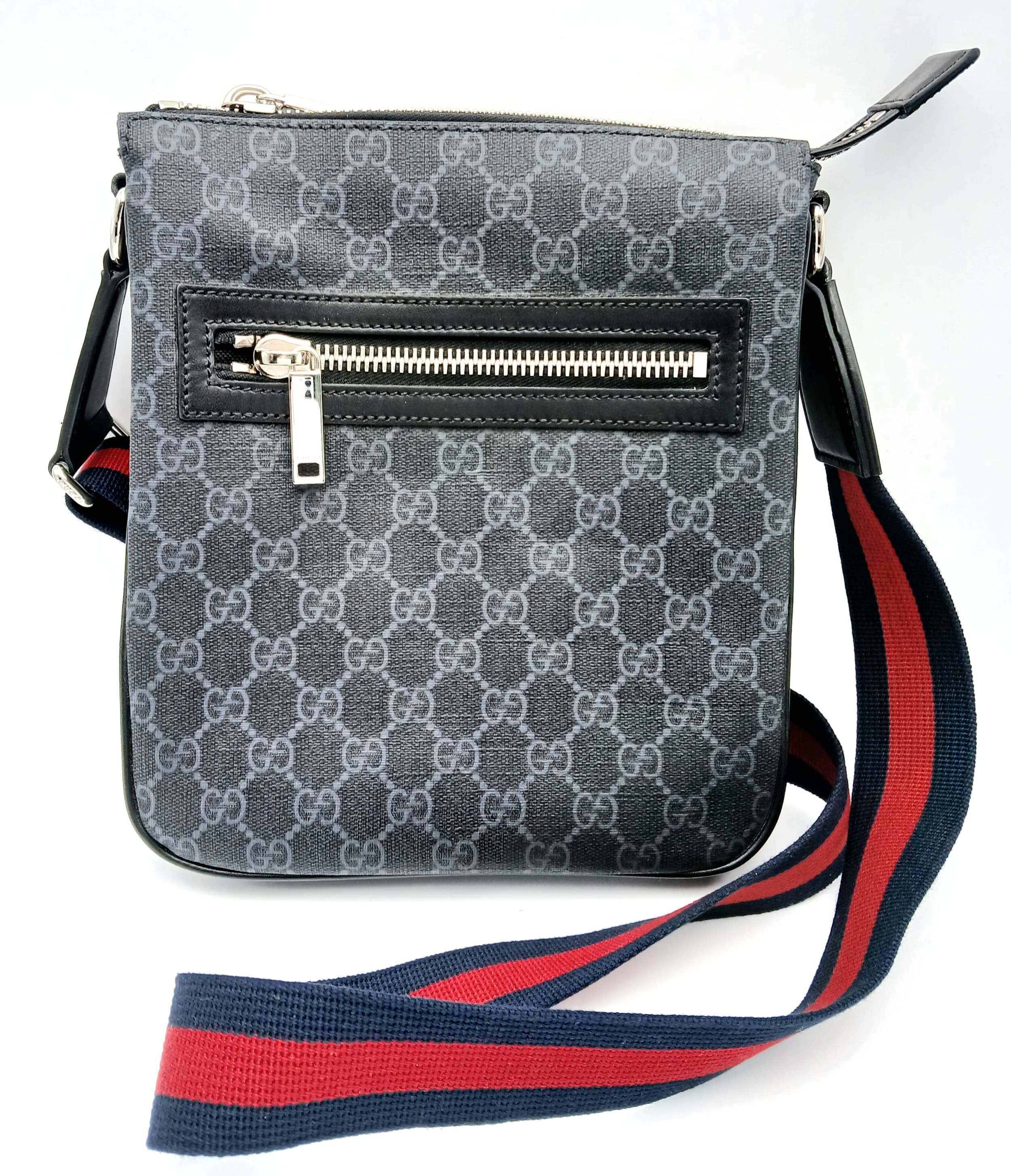 A Black Gucci GG Canvas Web Stripe Crossbody Bag.