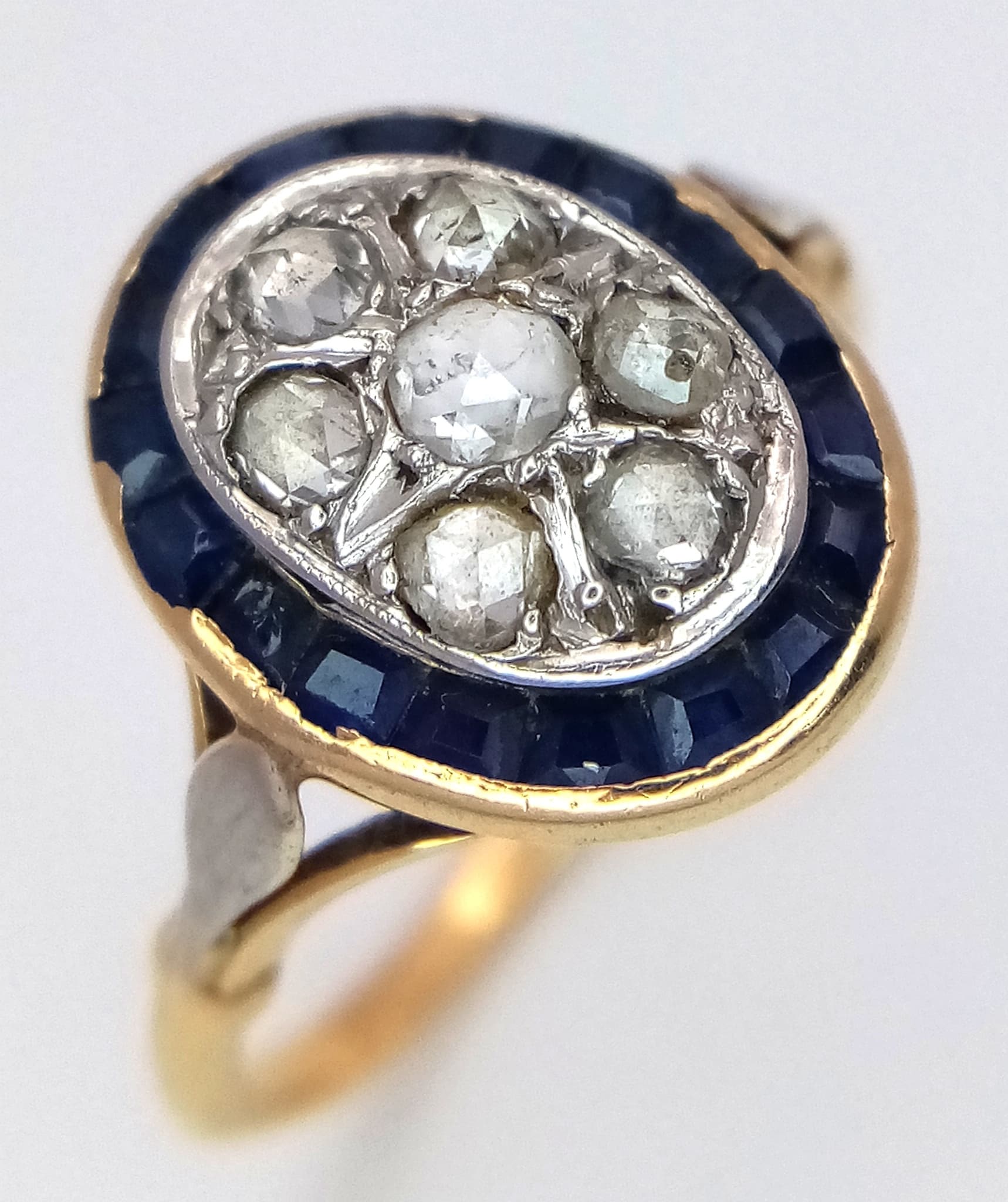 An Antique Art Deco 18K Gold (tests as) Diamond and Sapphire Ring. Rose cut diamonds with a sapphire surround. Size O. 3.3g total weight. Ref: 4.15.