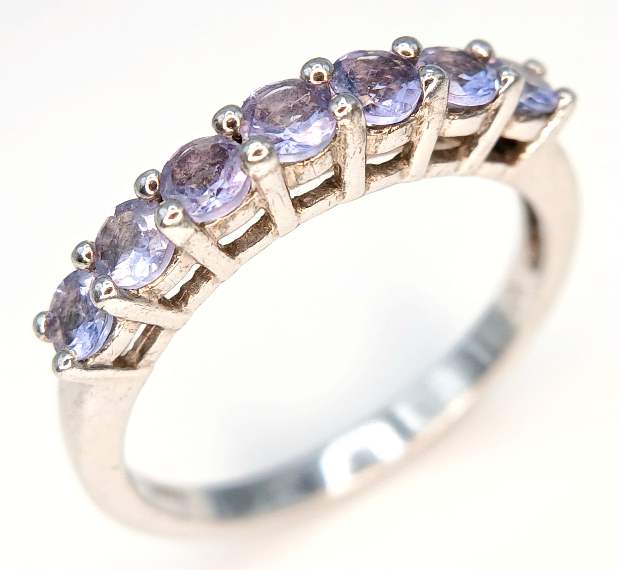 Classic Slim TANZANITE RING from The Genuine Gemstone Company. Having a Sweep of 7 x TANZANITE GEMSTONES set and Mounted in SILVER . Size P 1/2.