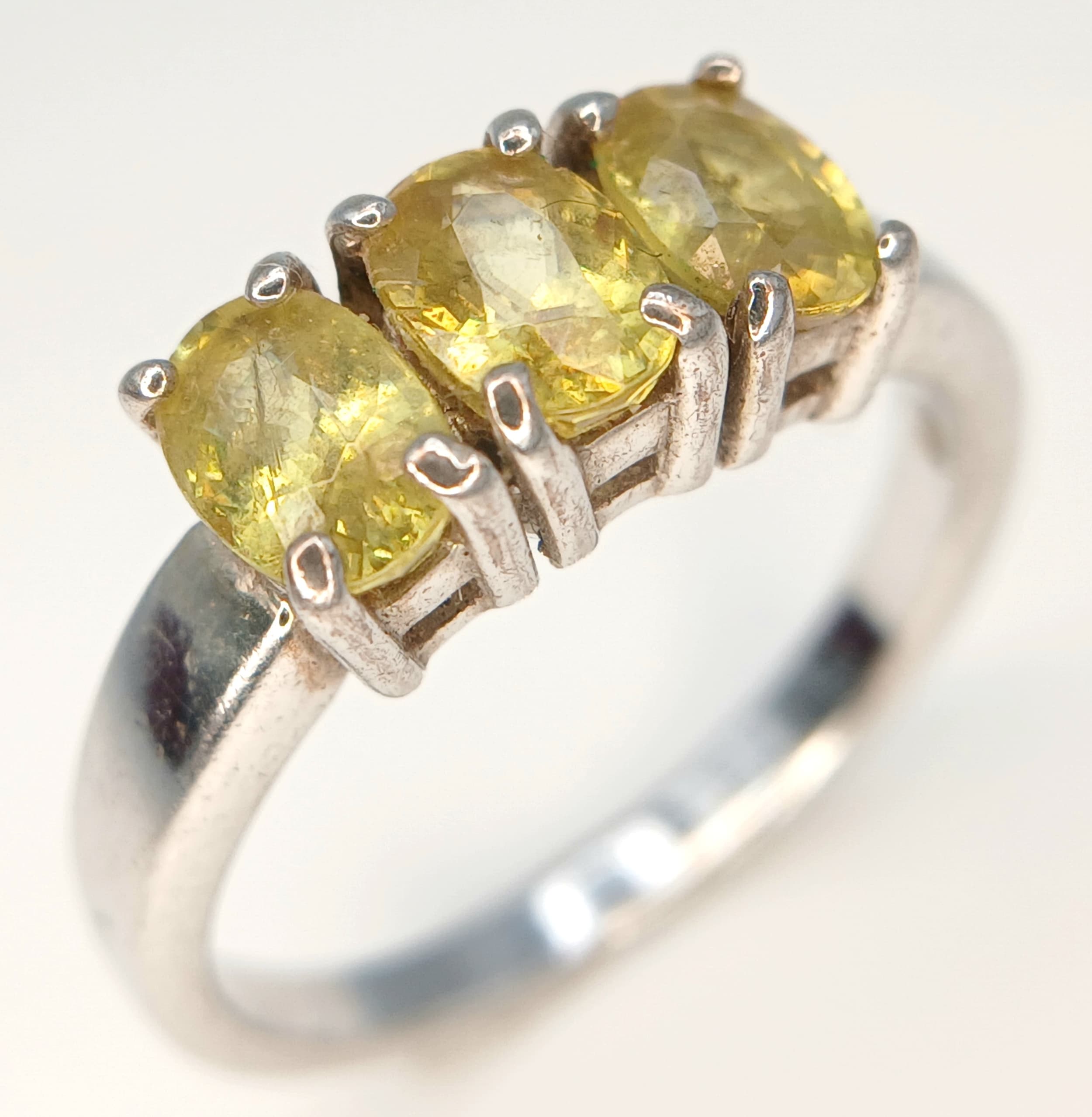 PERIDOT TRILOGY RING From The ‘Genuine Gemstone’ Company. Consisting 3 x Oval Cut PERIDOT GEMSTONES mounted on a 925 SILVER RING. Size O 1/2 - P.