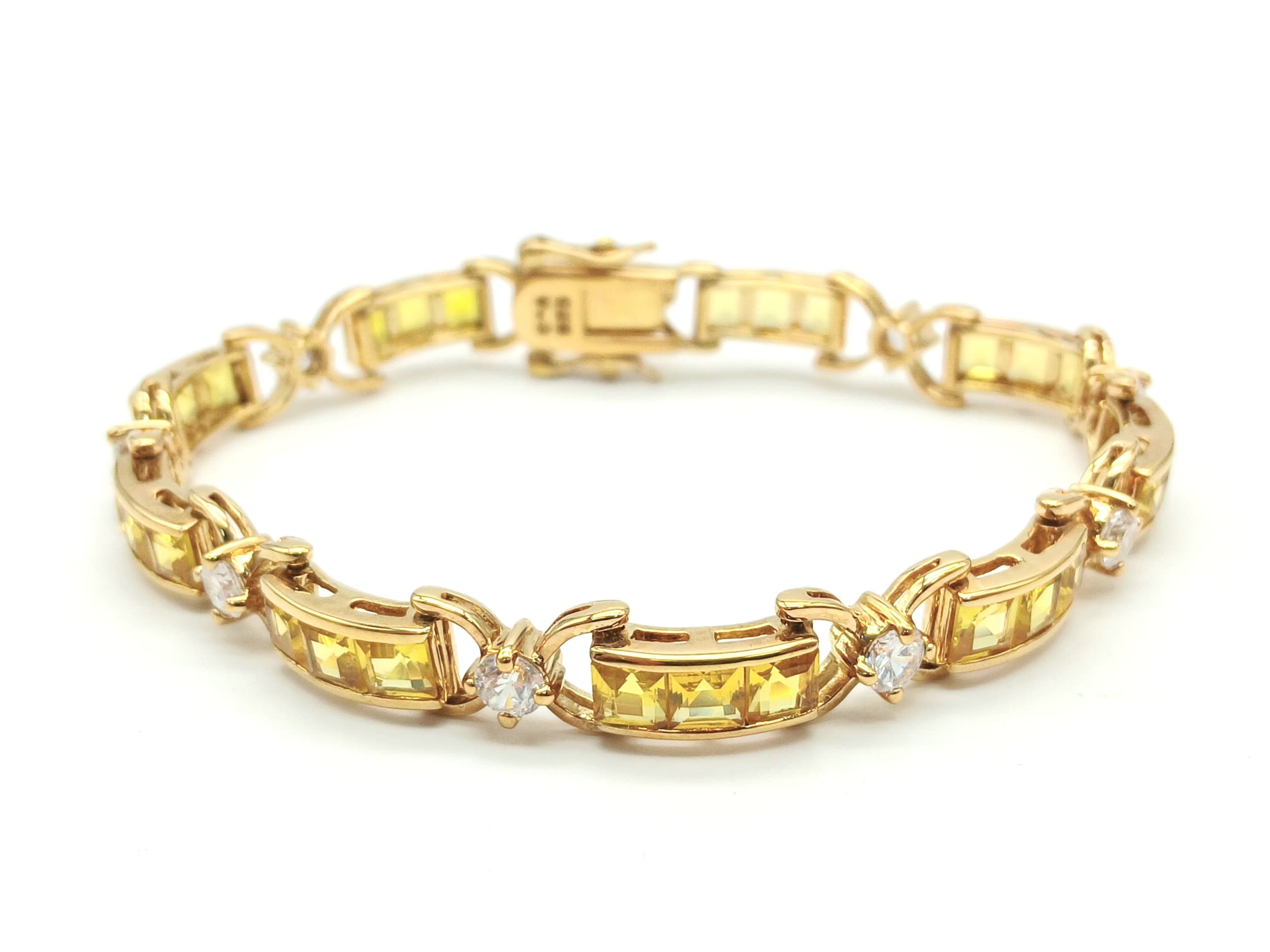A Stylish Gold Gilded Sterling Silver Yellow Sapphire and Cubic Zirconia Tennis Bracelet. 19cm Length. Set with Twenty-Seven 4mm Square CutYellow Sapphires and Nine 4mm Round Cut Cubic Zirconia. Gross weight18.08 Grams.