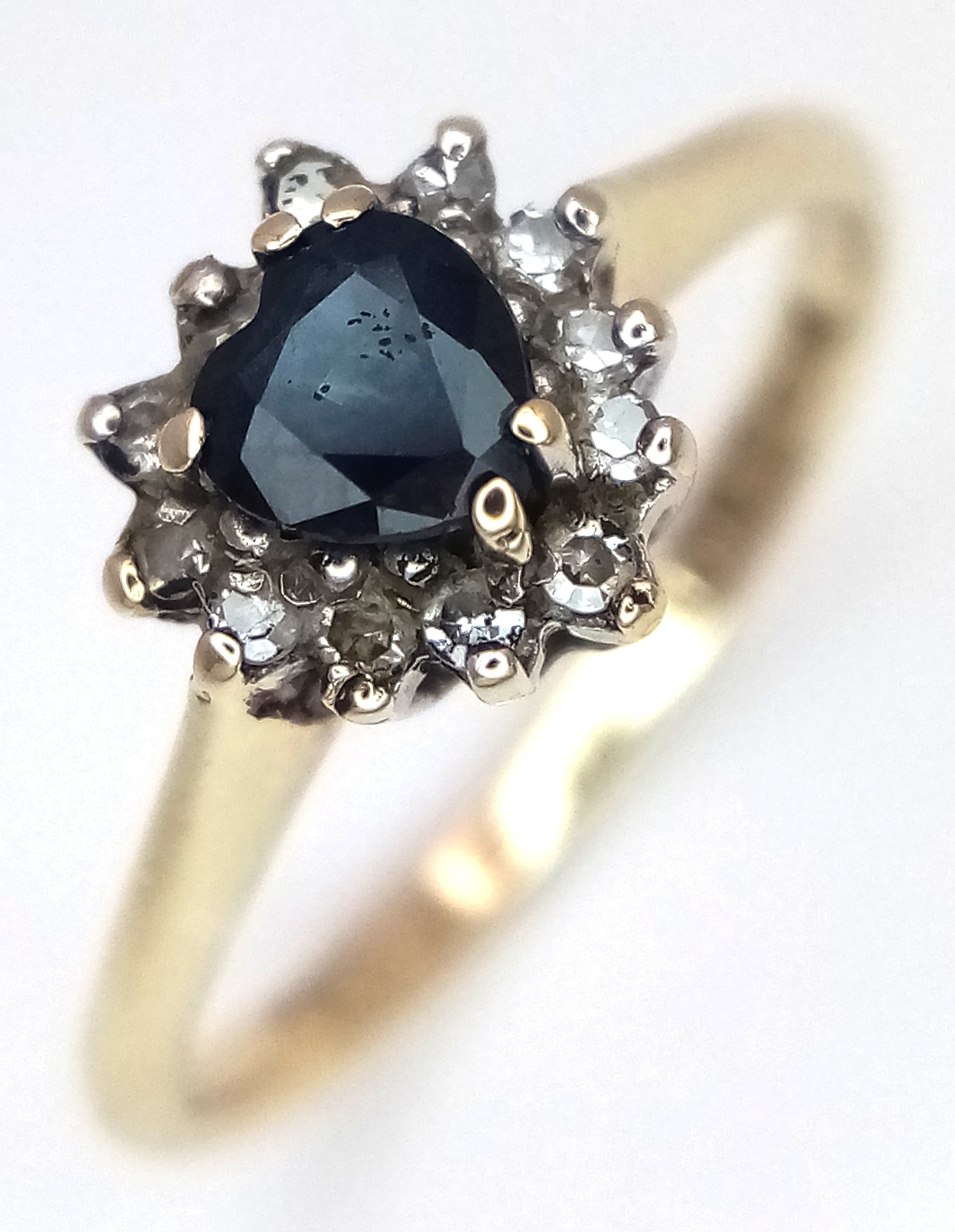A 9K YELLOW GOLD, DIAMOND AND SAPPHIRE SET, HEART SHAPED, CLUSTER RING. TOTAL WEIGHT 1.5G, SIZE I. SC 9031