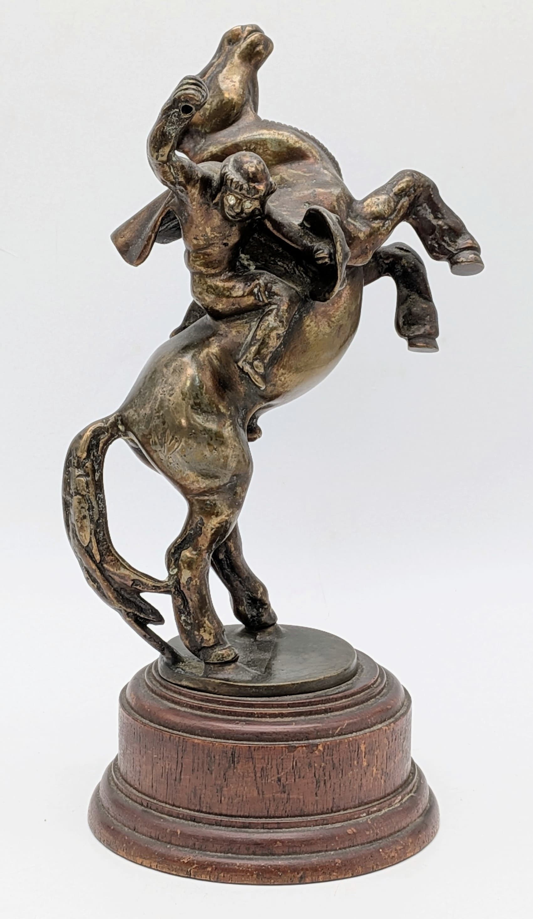 A Bronze Sculpture of a Moor Warrior on a Rearing Horse. Set on a wooden base. Note: hand weapon is missing. 29cm.