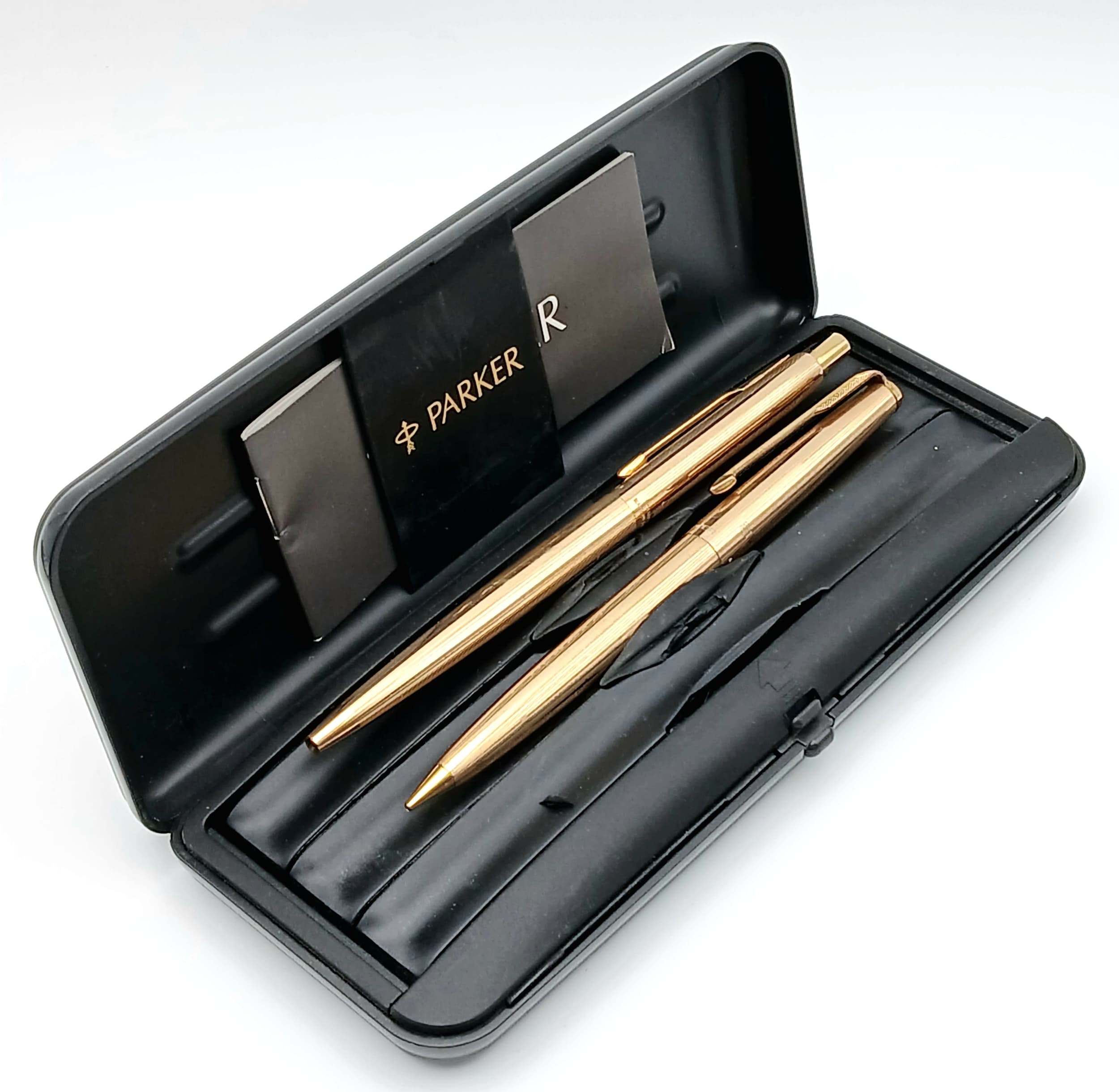 A Parker Rolled Gold Pen Set. Comprising a ballpoint pen and pencil. Both marked Rolled Gold, Made in England. Comes with Parker case and booklet.
