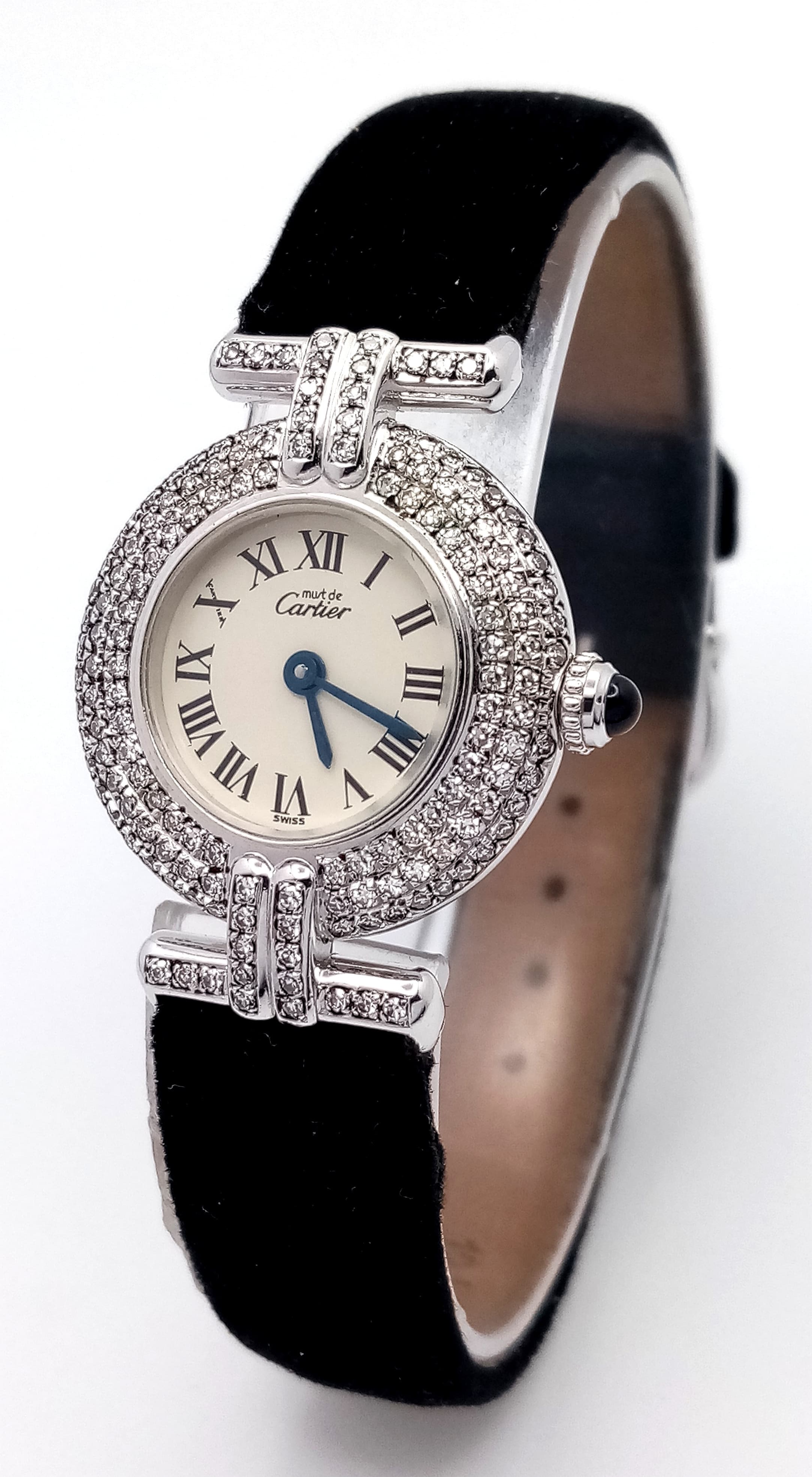 A Must de Cartier Diamond Ladies Quartz Watch. Velvet strap. Sterling silver plated case - 24mm. Diamond encrusted bezel and lugs. White dial with Roman numerals. Sapphire tipped crown. In working order. Professionally custom fitted with diamonds.