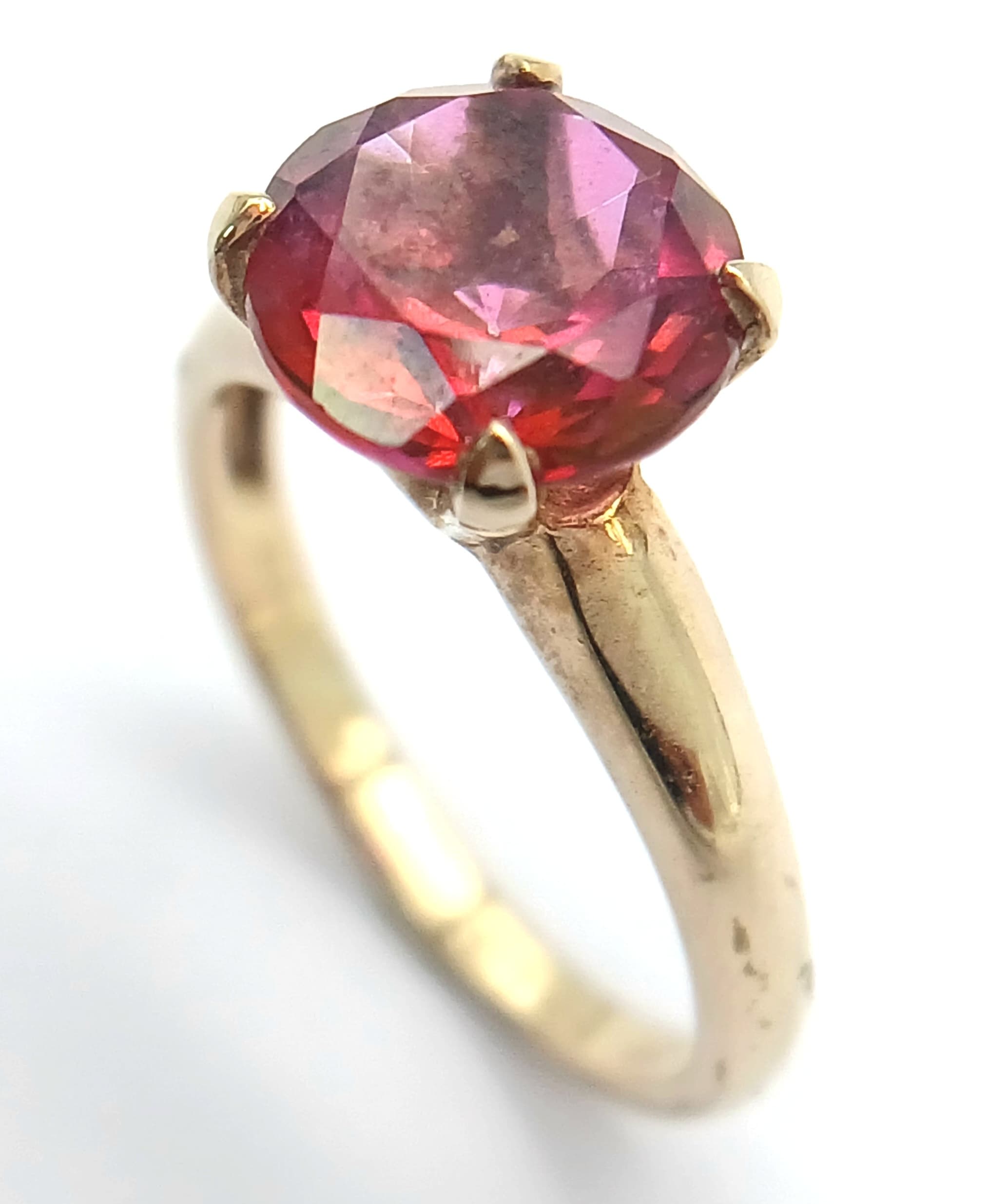 A 9K Yellow Gold Red Stone Solitaire Ring. Size N, 3.2g total weight.