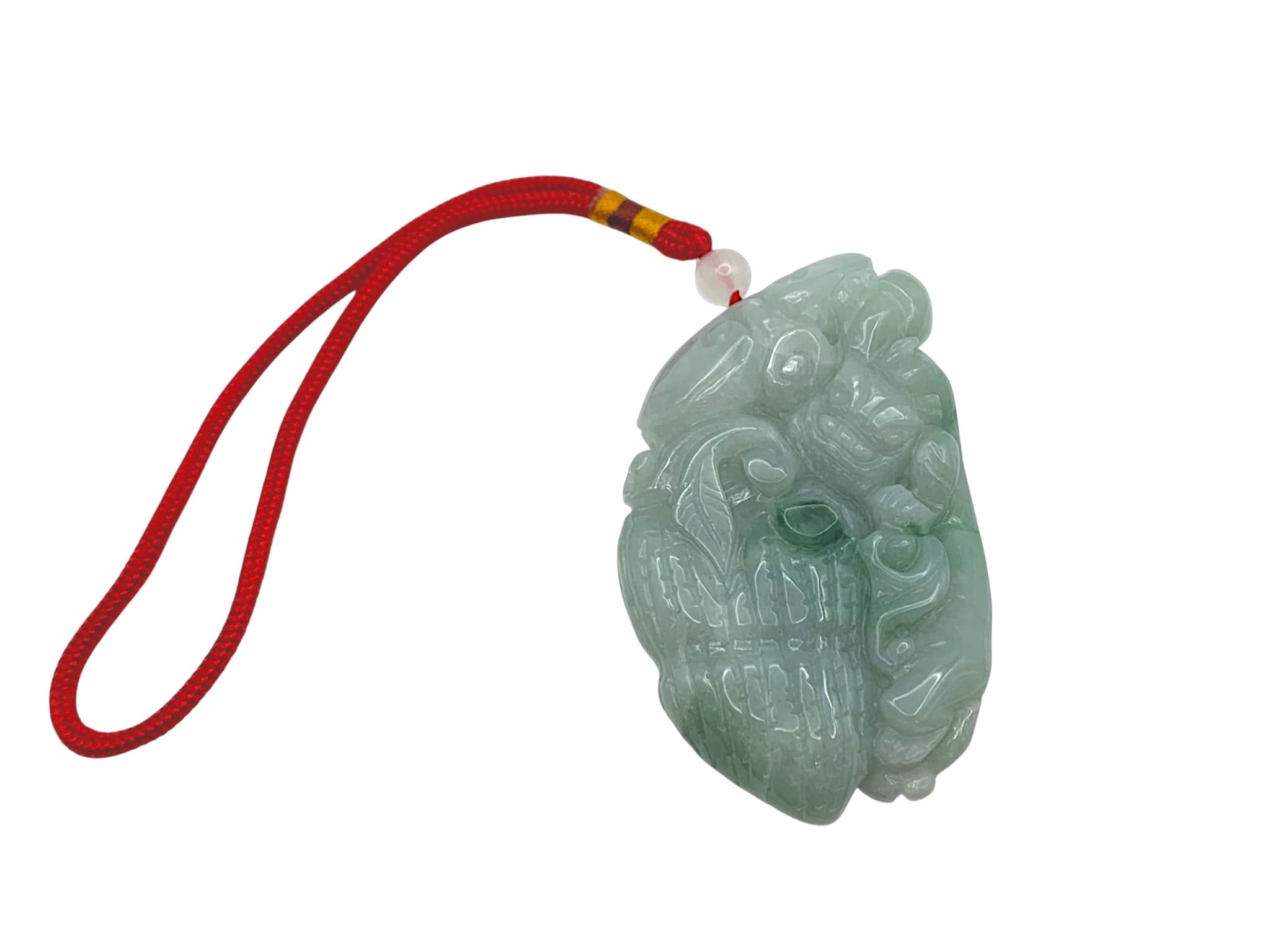 A Large Carved Jade ‘Dragon and Cloud’ Pendant. Pale celadon-green jade, carved in relief as a dragon among clouds, with darker green inclusions, suspended from a cord. Dimensions: 13cm × 8cm × 5cm. Weight: 380g.
