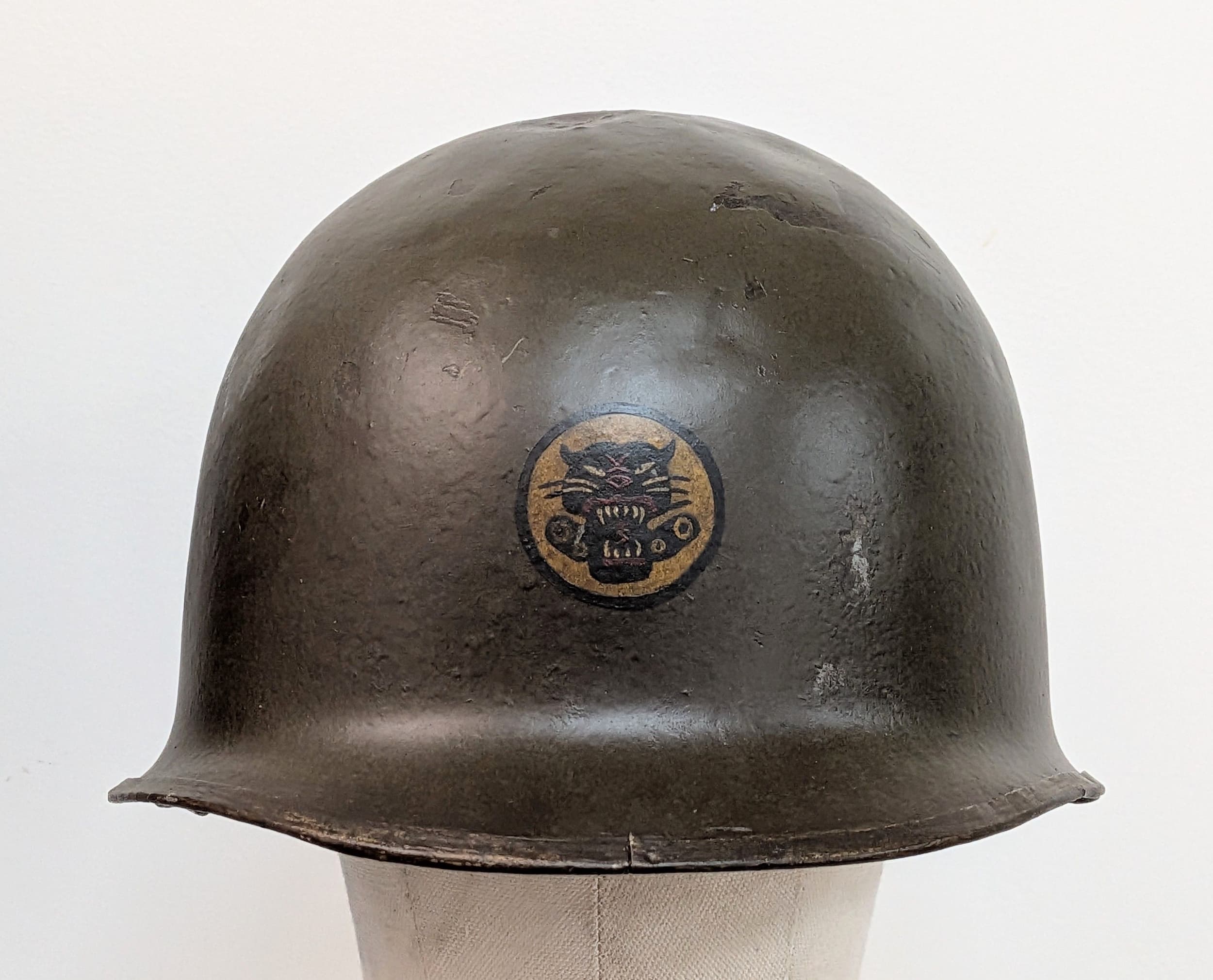 WW2 US Front Seam M1 Helmet with Capac liner Shell. With painted insignia of the Tank Destroyer Battalion