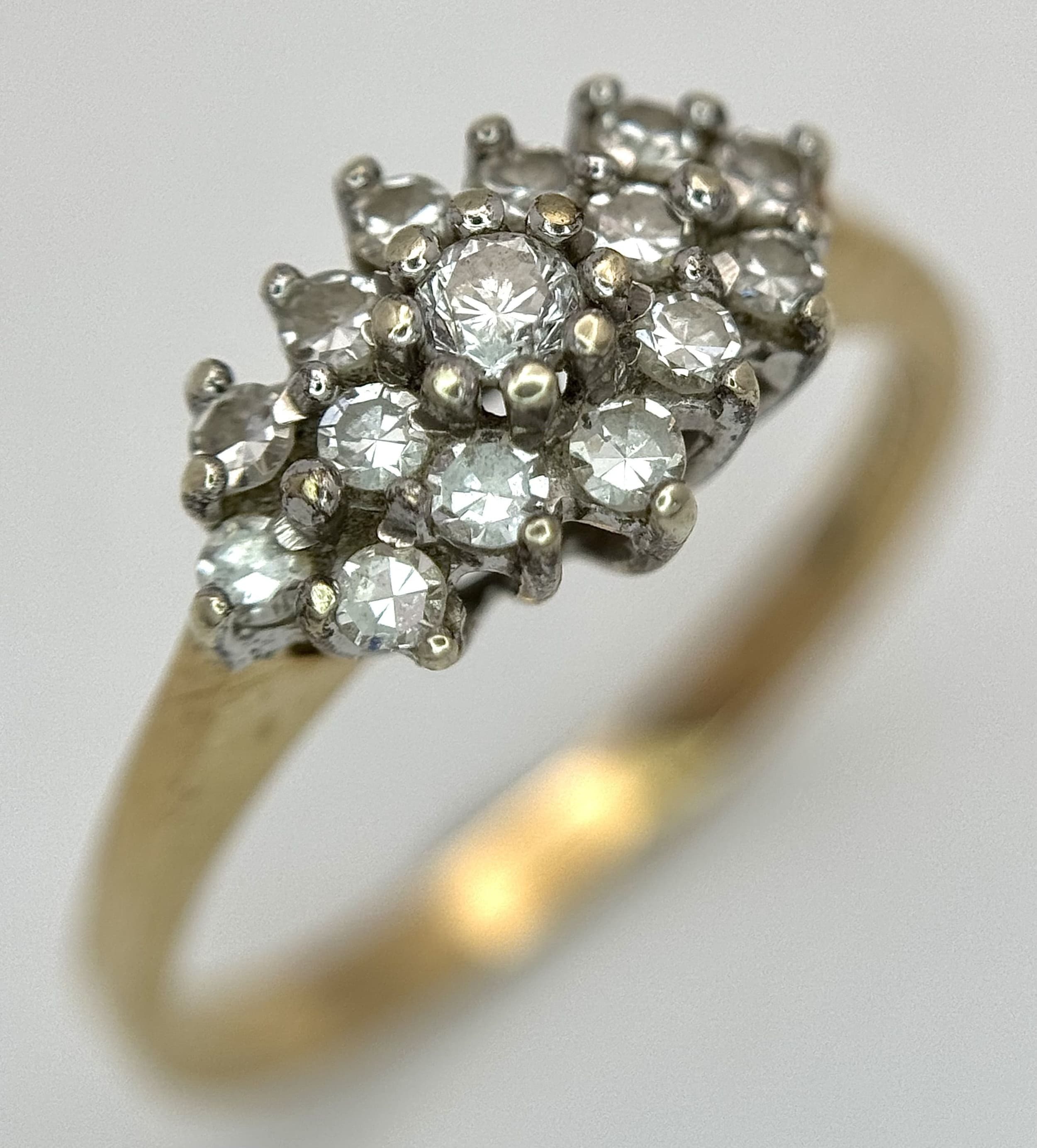 A 9K Yellow Gold Diamond Cluster Ring. c.60ctw of round brilliant cut diamonds in a micro-claw setting. Size N. 2.2g total weight.