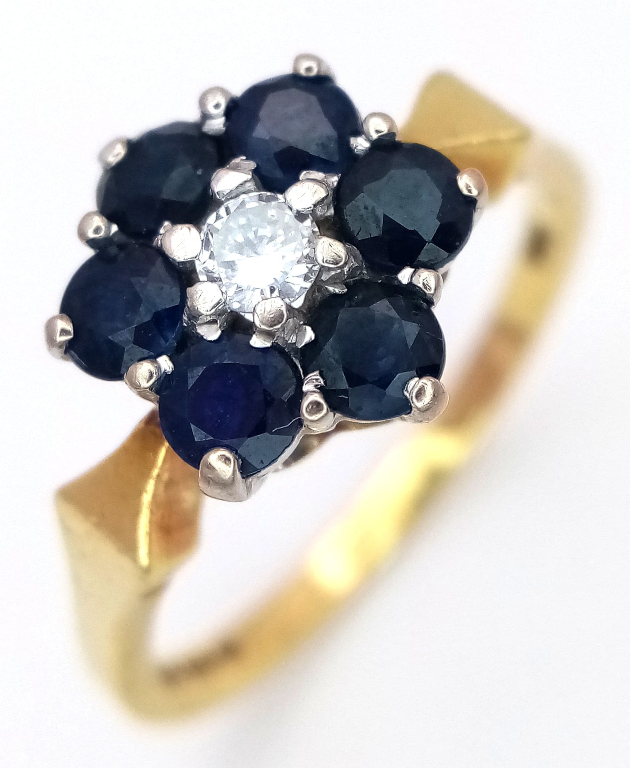 Fully hallmarked 18 CARAT GOLD SAPPHIRE CLUSTER RING with CENTRE DIAMOND. Attractive Geometric Shoulders. 4.0 Grams. Size P 1/2 - Q. Beautiful Ring , Please see pictures.