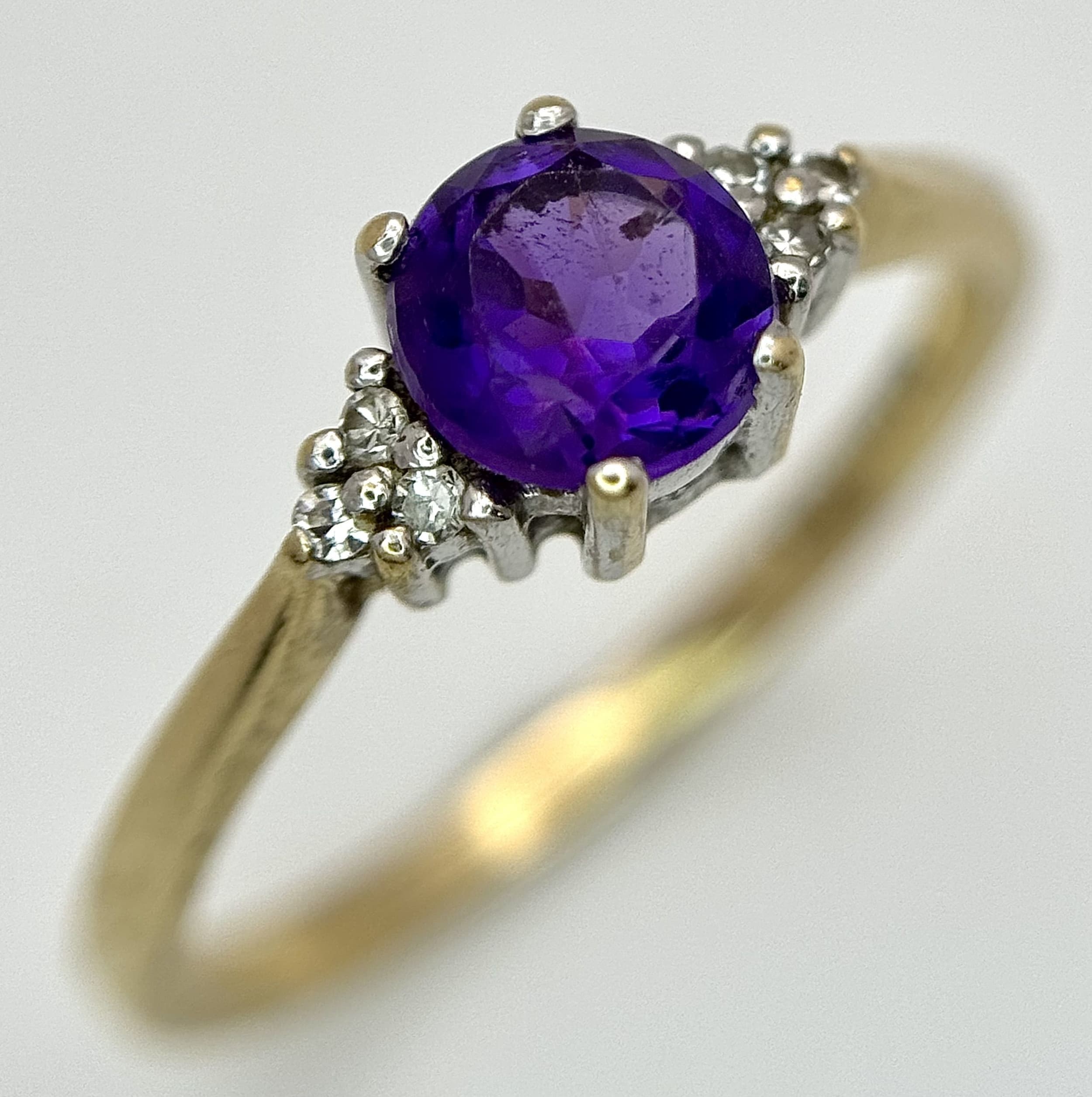 A 9K Yellow Gold Amethyst Ring with Diamond Accents. Size M 1/2. 1.75g total weight.