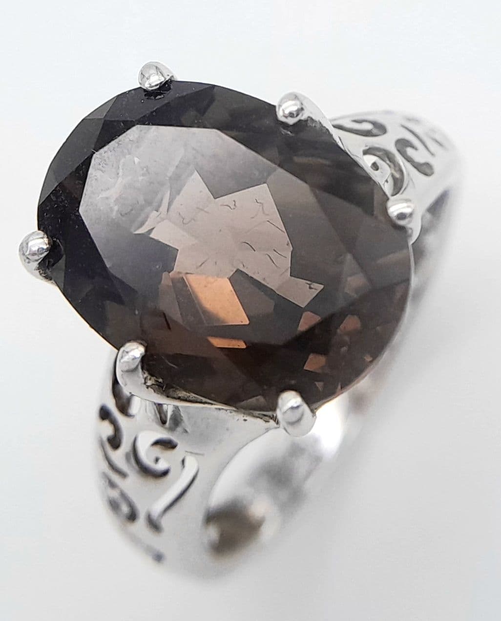 Impressive SILVER and SMOKEY QUARTZ RING. Consisting a large OVAL CUT SMOKEY QUARTZ GEMSTONE set in a SILVER RING with Beautiful Pierced Silver Shoulders. Size N.