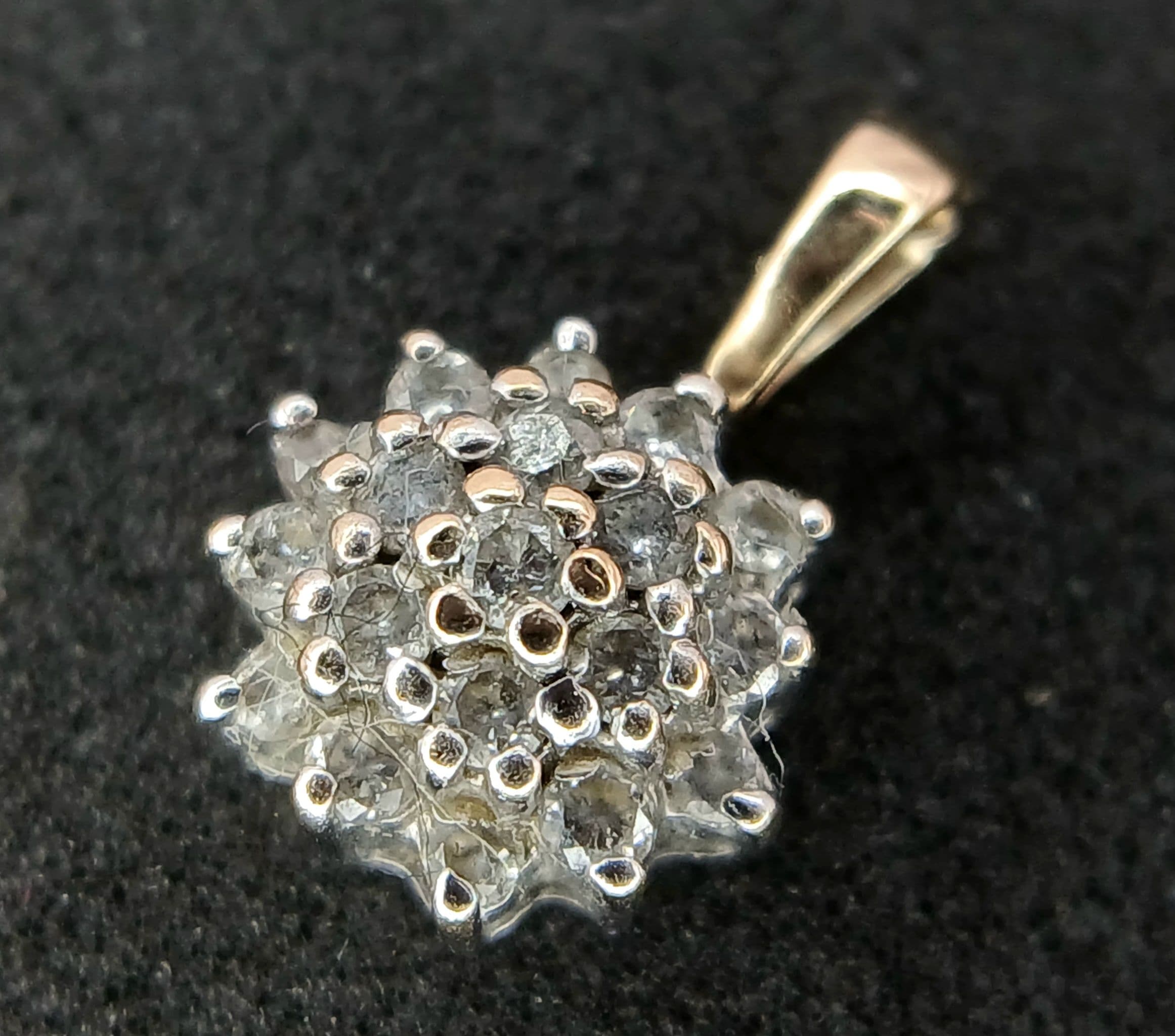A Vintage 9k (Tests minimum 9k) Yellow and White Gold Diamond Cluster Pendant 0.25 CTW. The pendant measures 9mm Wide and has a gross weight of 0.75 grams.