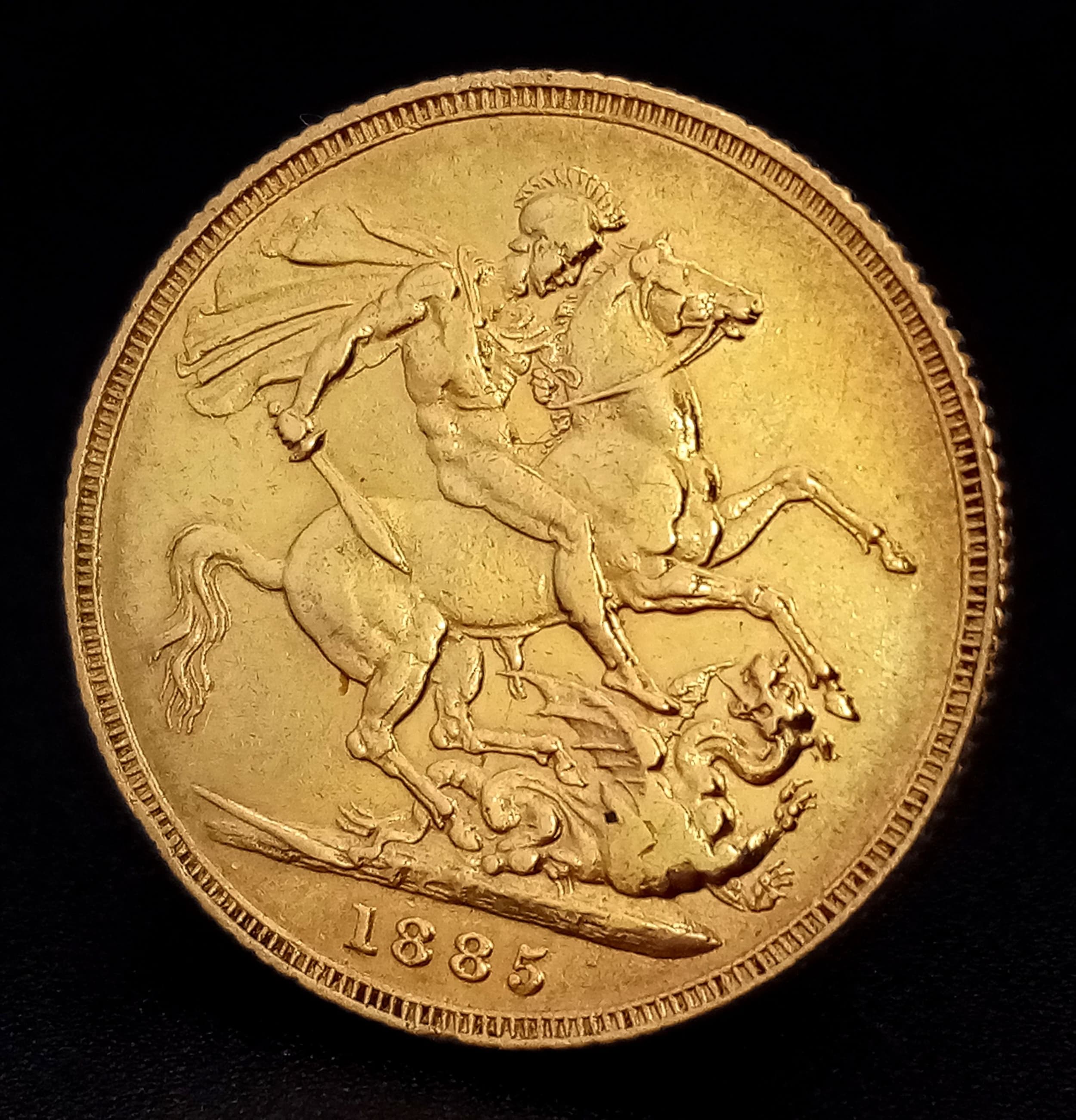 AN 1885 DATED FULL SOVEREIGN COIN MINTED IN SYDNEY WITH THE YOUNG VICTORIA HEAD IN 22K GOLD.