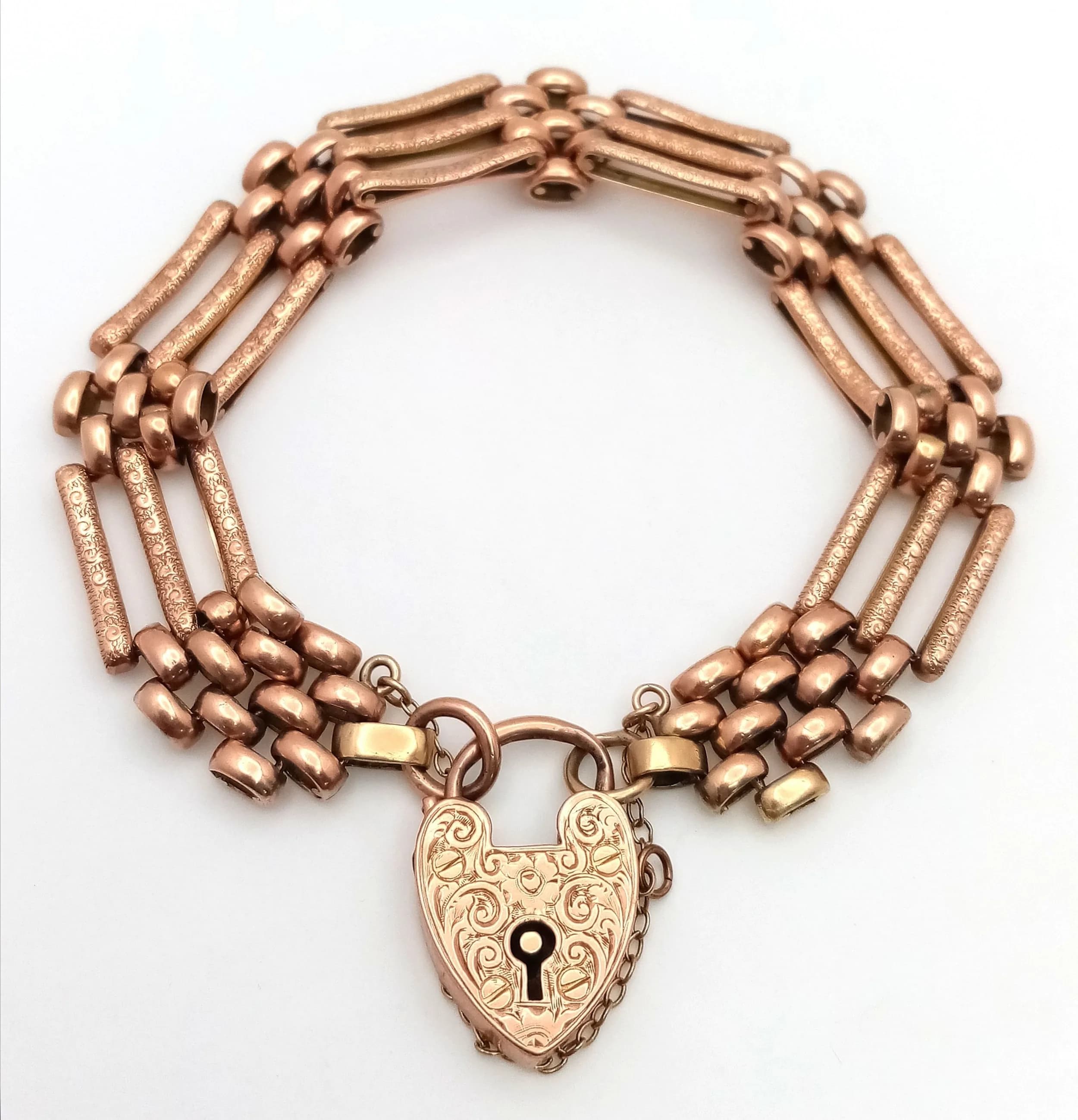 A 9K Rose Gold Fancy Gate Bracelet with Heart Clasp and Decorative Gates. Safety chain. Good condition. 25.4g