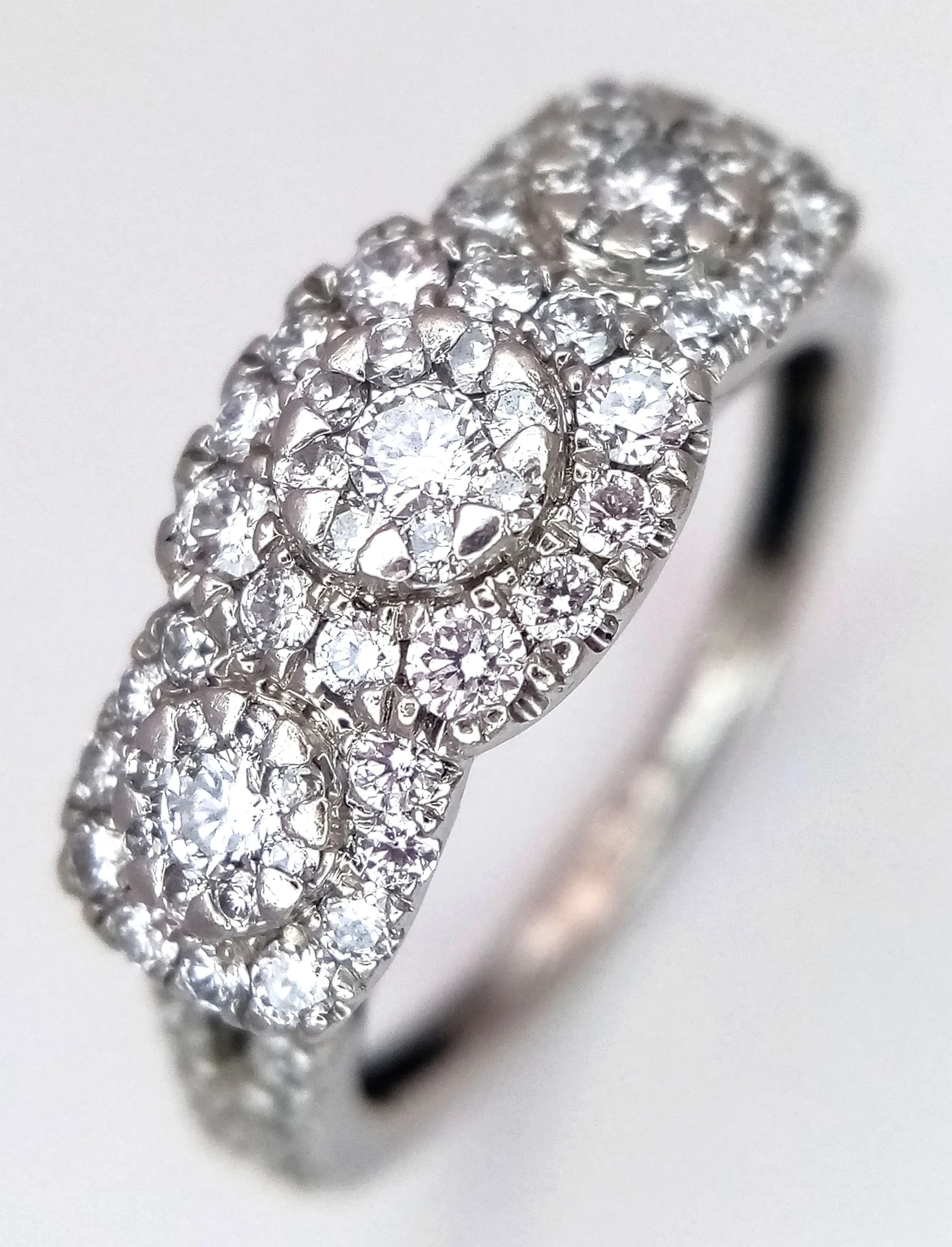 A PLATINUM, DIAMOND SET, TRIPLE CLUSTER RING. 0.50CTW. 4.5G, SIZE L. SC 5099