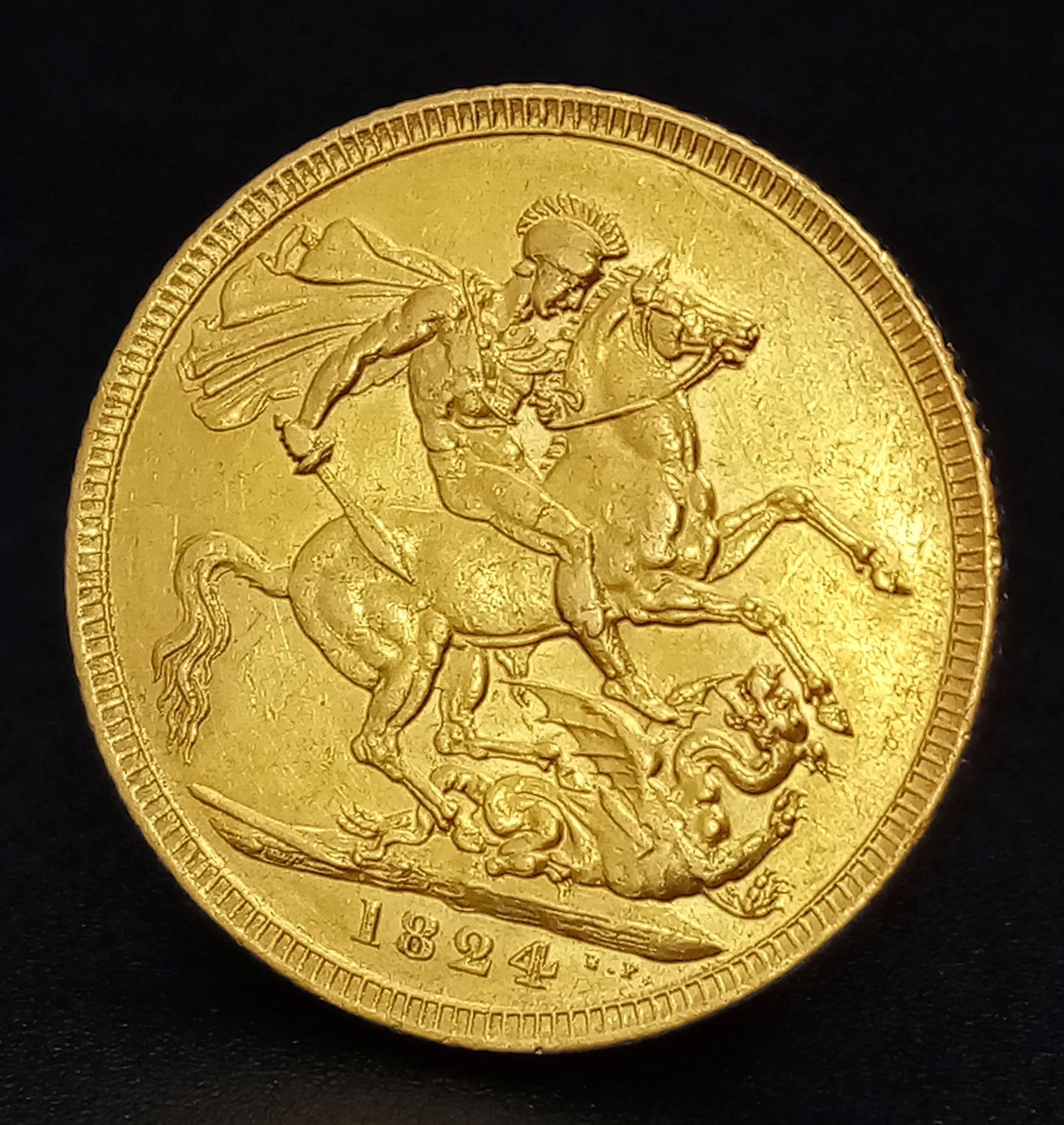 A Rare 1824 George IV Gold Sovereign Coin. Obverse with laureate head portrait of King George IV, reverse with St George and the Dragon design. Dated 1824. EF condition.