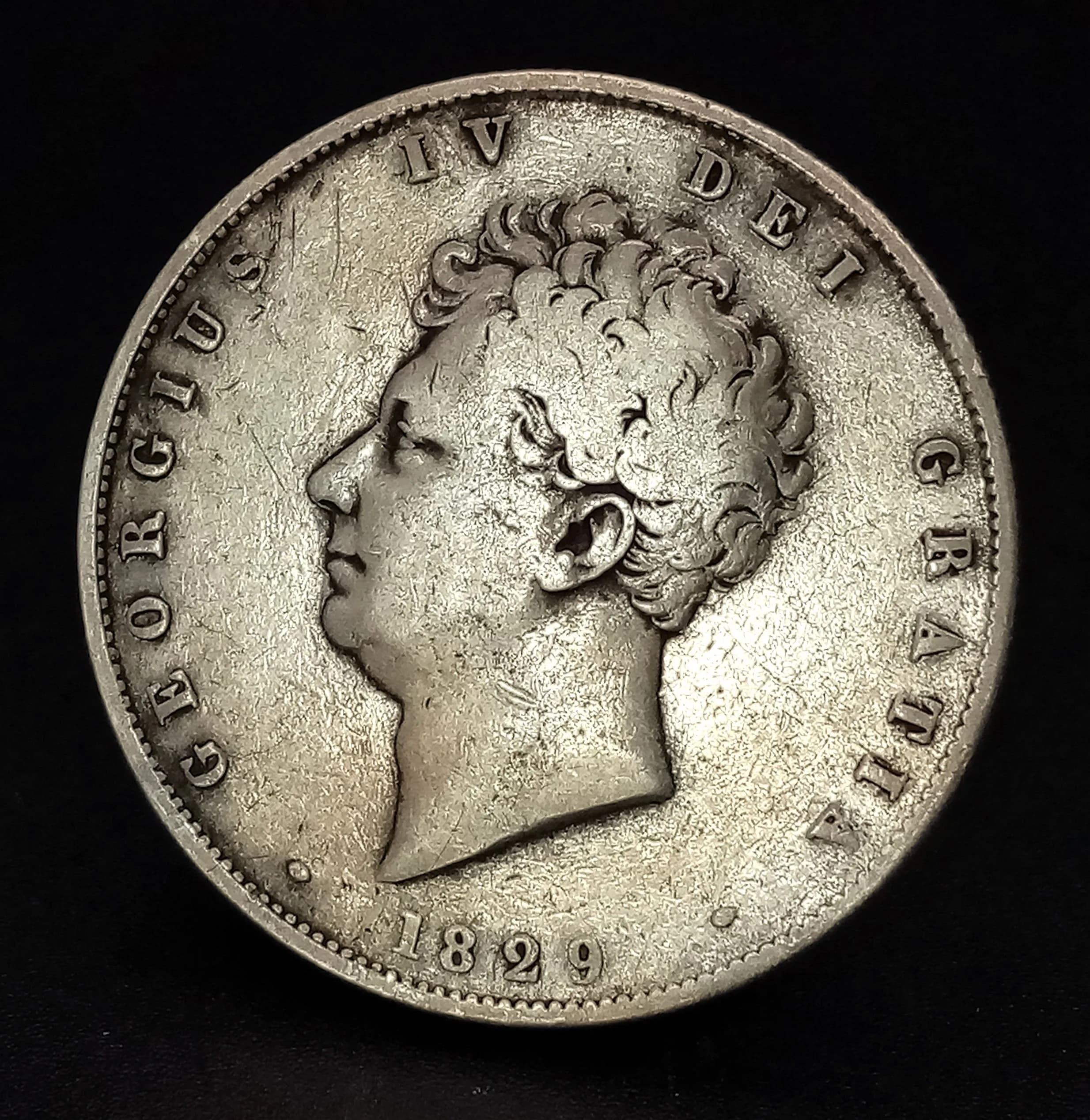A Rare 1829 George IV Silver Half Crown Coin. Obverse with bare head portrait of King George IV, reverse with crowned shield design. Dated 1829.