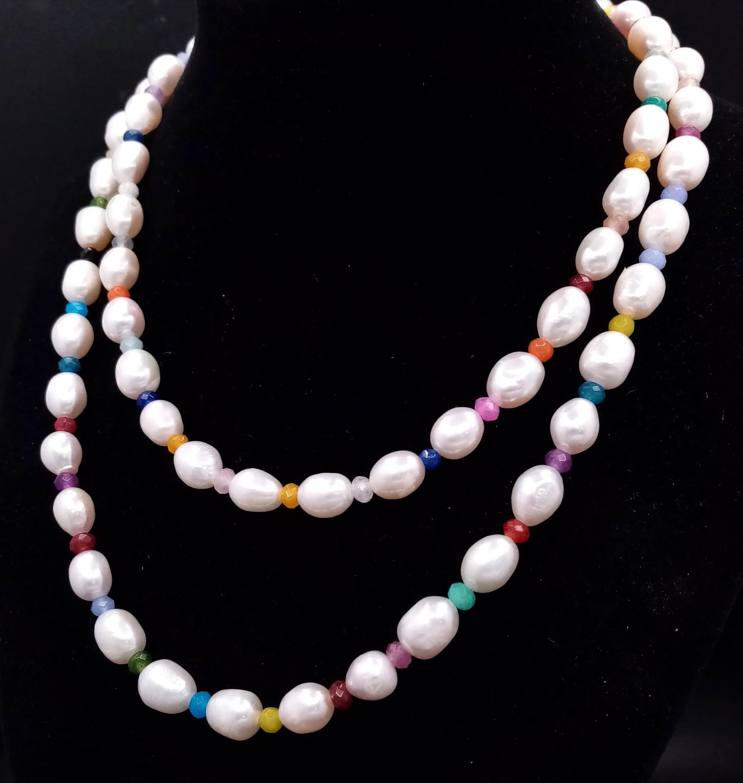 A Freshwater White Rice Pearl Necklace with Multi-Coloured Jade Spacers. 80cm length.
