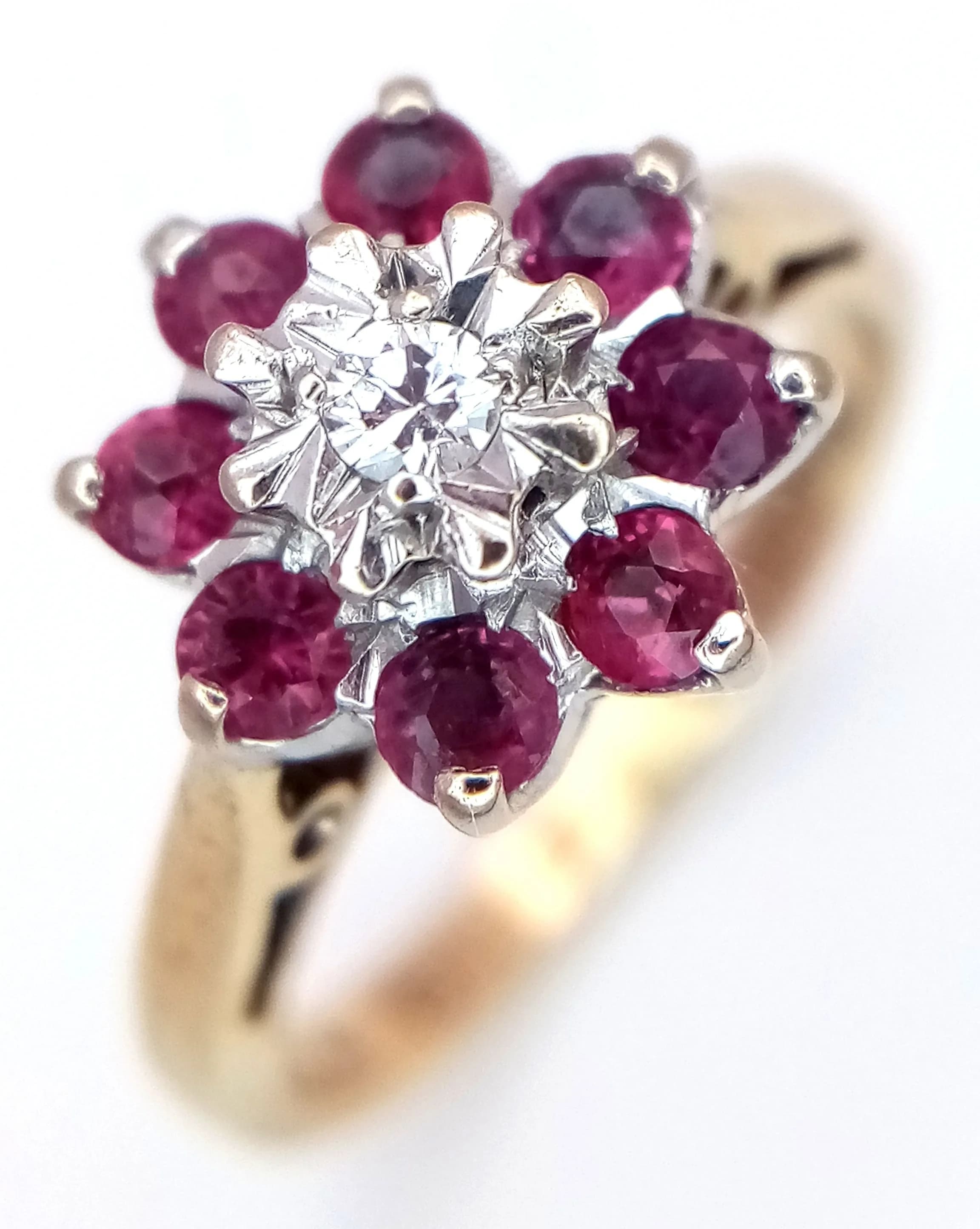 A 9K YELLOW GOLD, DIAMOND AND RUBY SET, CLUSTER RING. 2.6G, SIZE H. SC 5005
