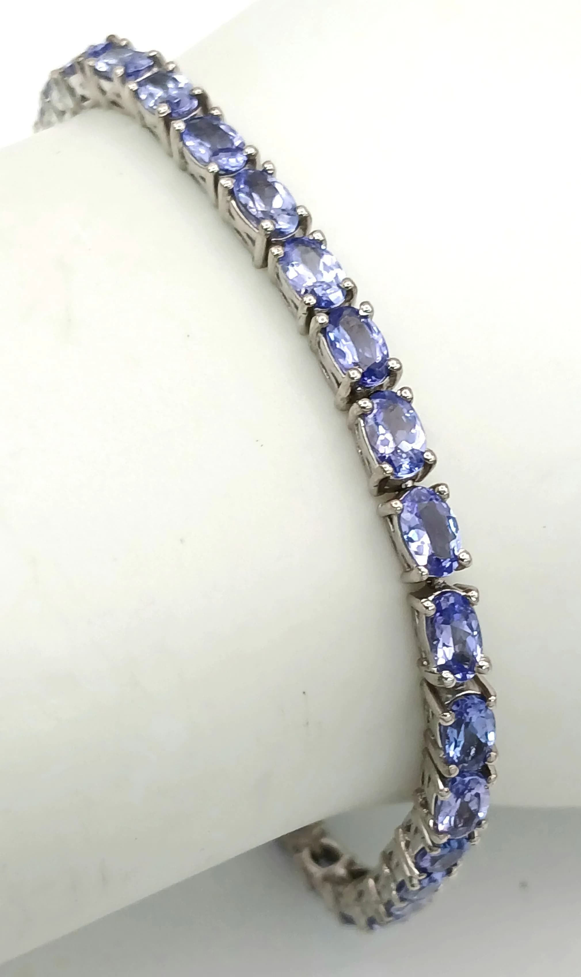 A Pretty Sterling Silver Tanzanite Set Tennis Bracelet-19cm Length. Set with Thirty-Four 4.5 x 3mm Oval Cut Tanzanite, approximately 8 to 8.5 carat total. Gross Weight 8.86 grams