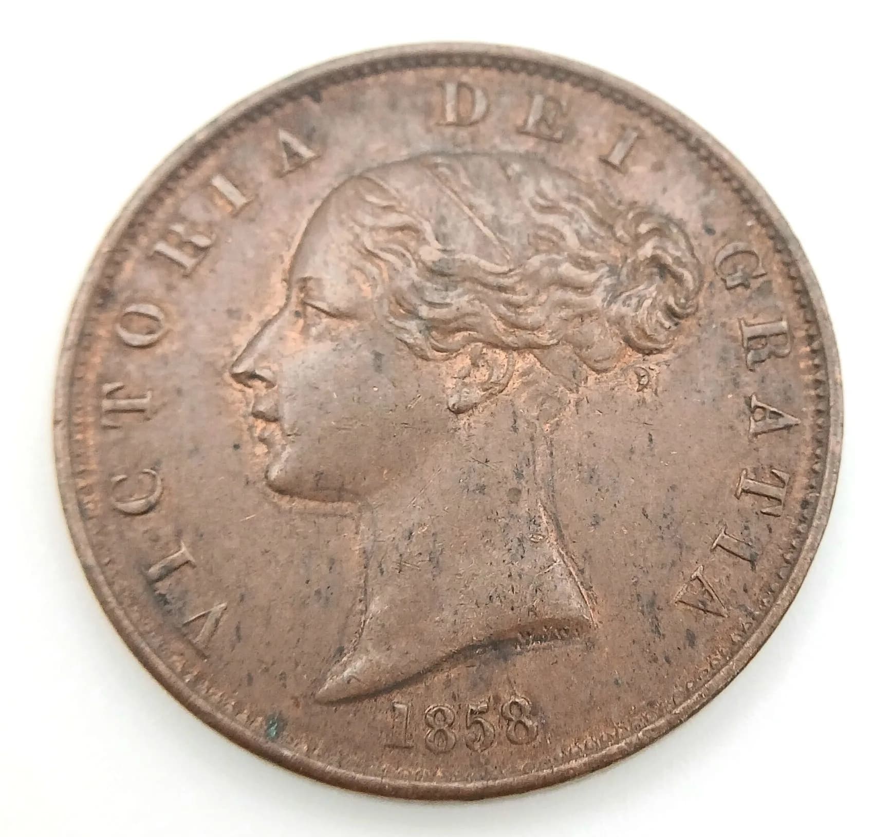 An 1858 Victoria Halfpenny Coin.