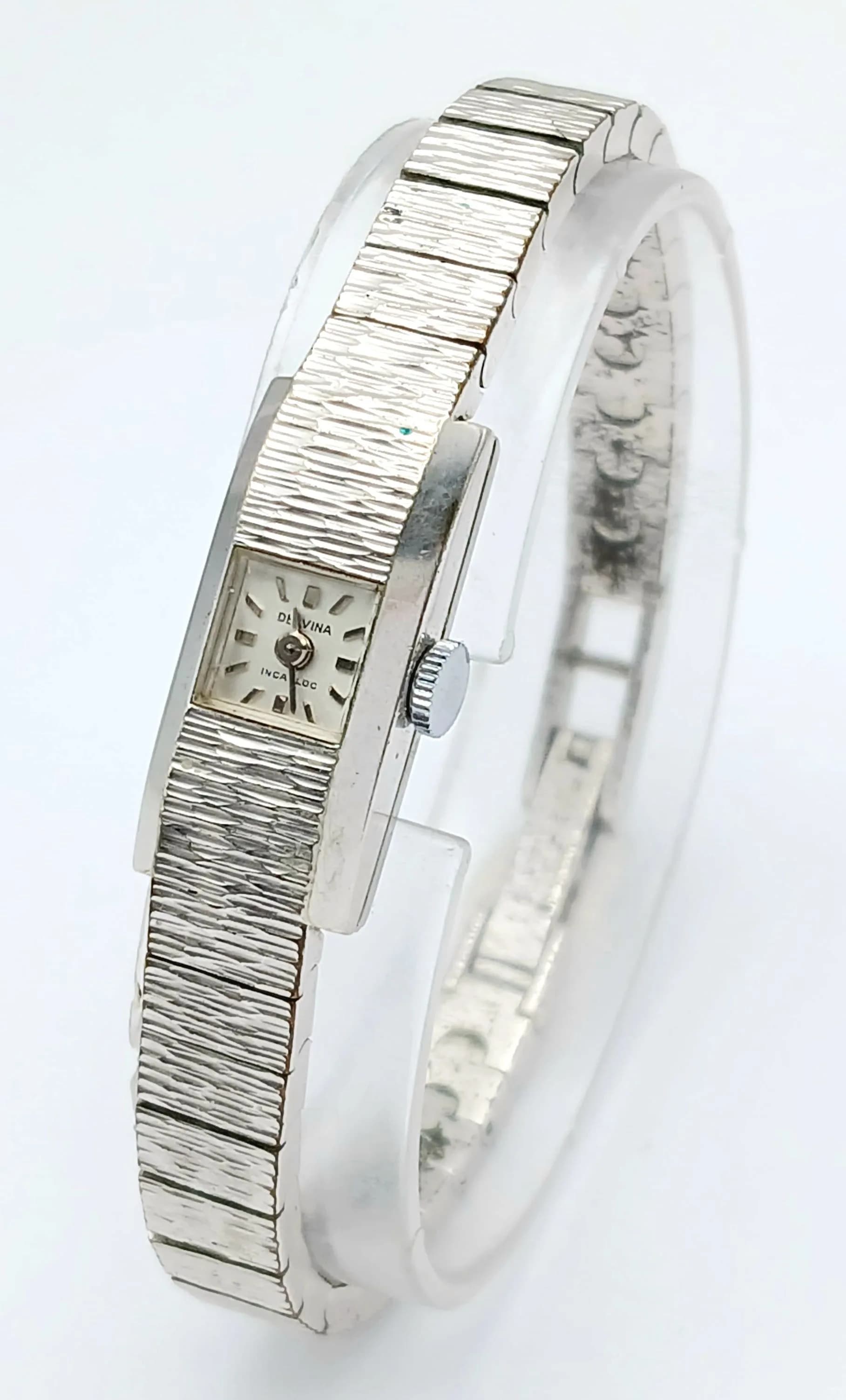Ladies Vintage ‘DELVINA’ COCKTAIL WRISTWATCH. Silver Tone Bark Effect. Bracelet Strap. Swiss Made. Manual winding. Full working order. Excellent condition, please see pictures.