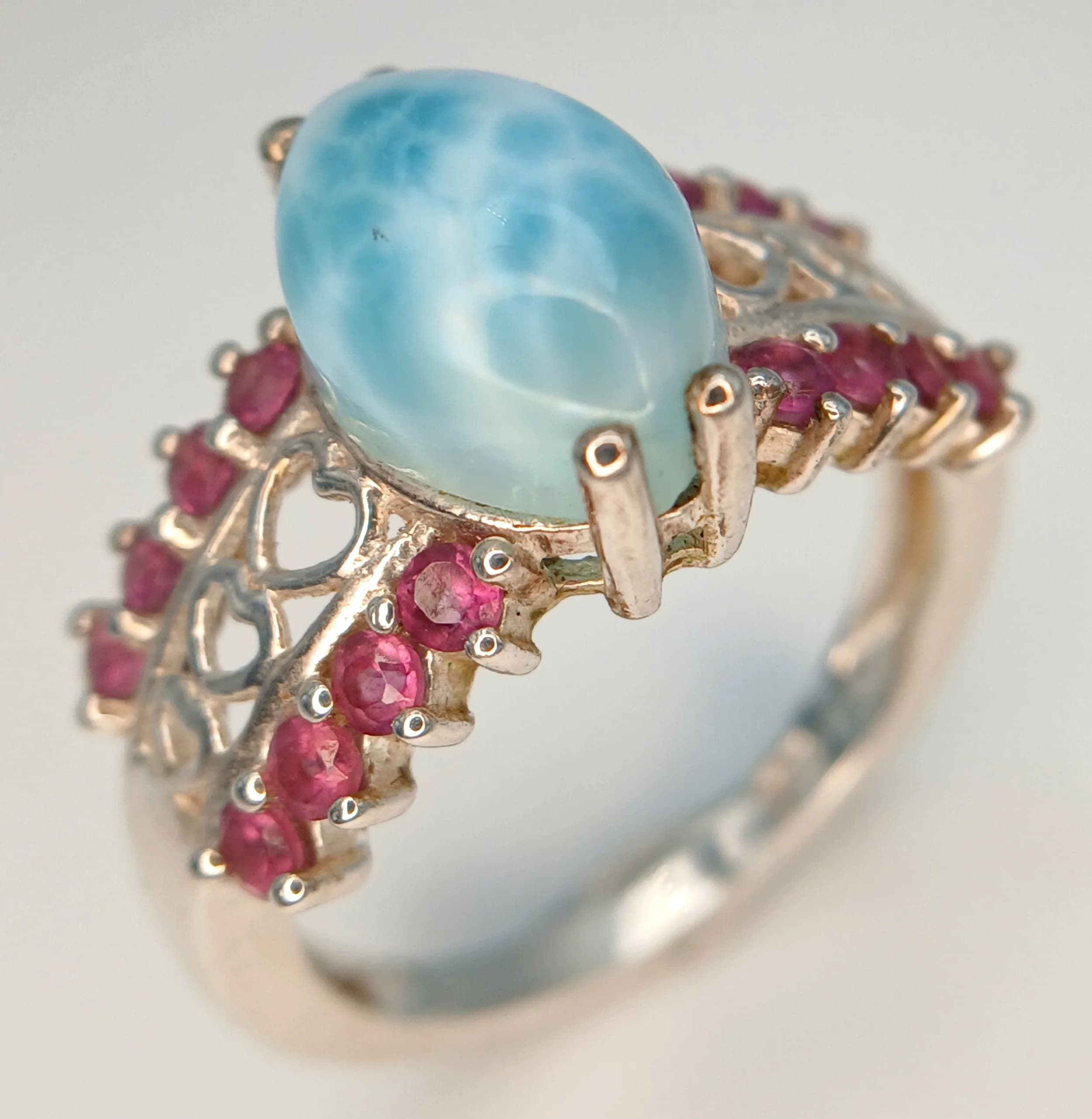 A Pretty Sterling Silver Larimar and Pink Tourmaline Love Heart Ring. Size O. The Ring is set with a 12 x 8mm Oval Cut Larimar with Round Cut Pink Tourmaline in the Shoulders. Gross weight 3.93 grams.