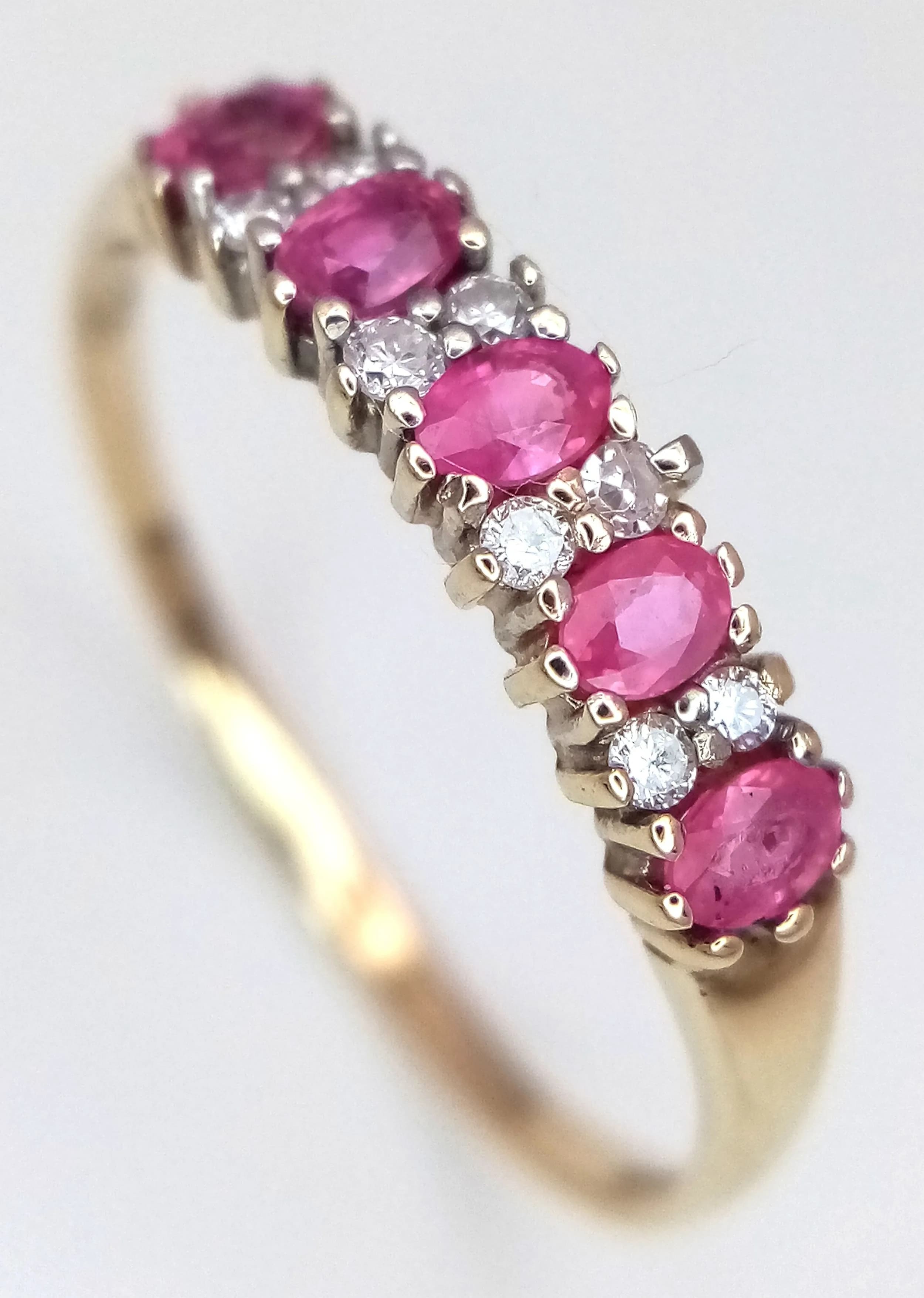 A 9K YELLOW GOLD, DIAMOND AND RUBY SET RING. 0.10CTW. 1.5G, SIZE U. A/S RED 2