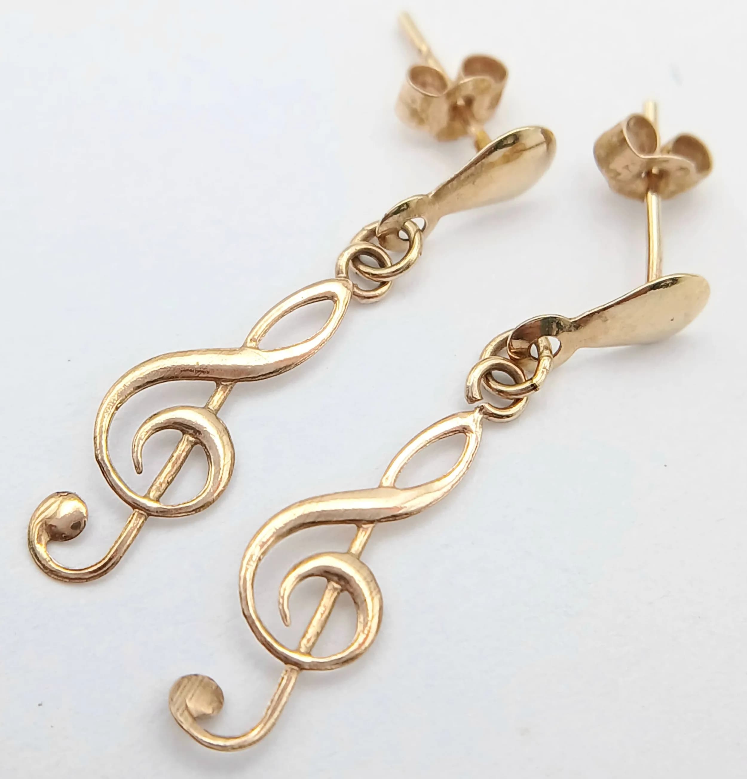 A Unique Pair of 9k Yellow Gold ‘Treble Clef’ Musical Note Earrings. 2.5cm length. Combined weight 0.28 grams. Come in presentation box