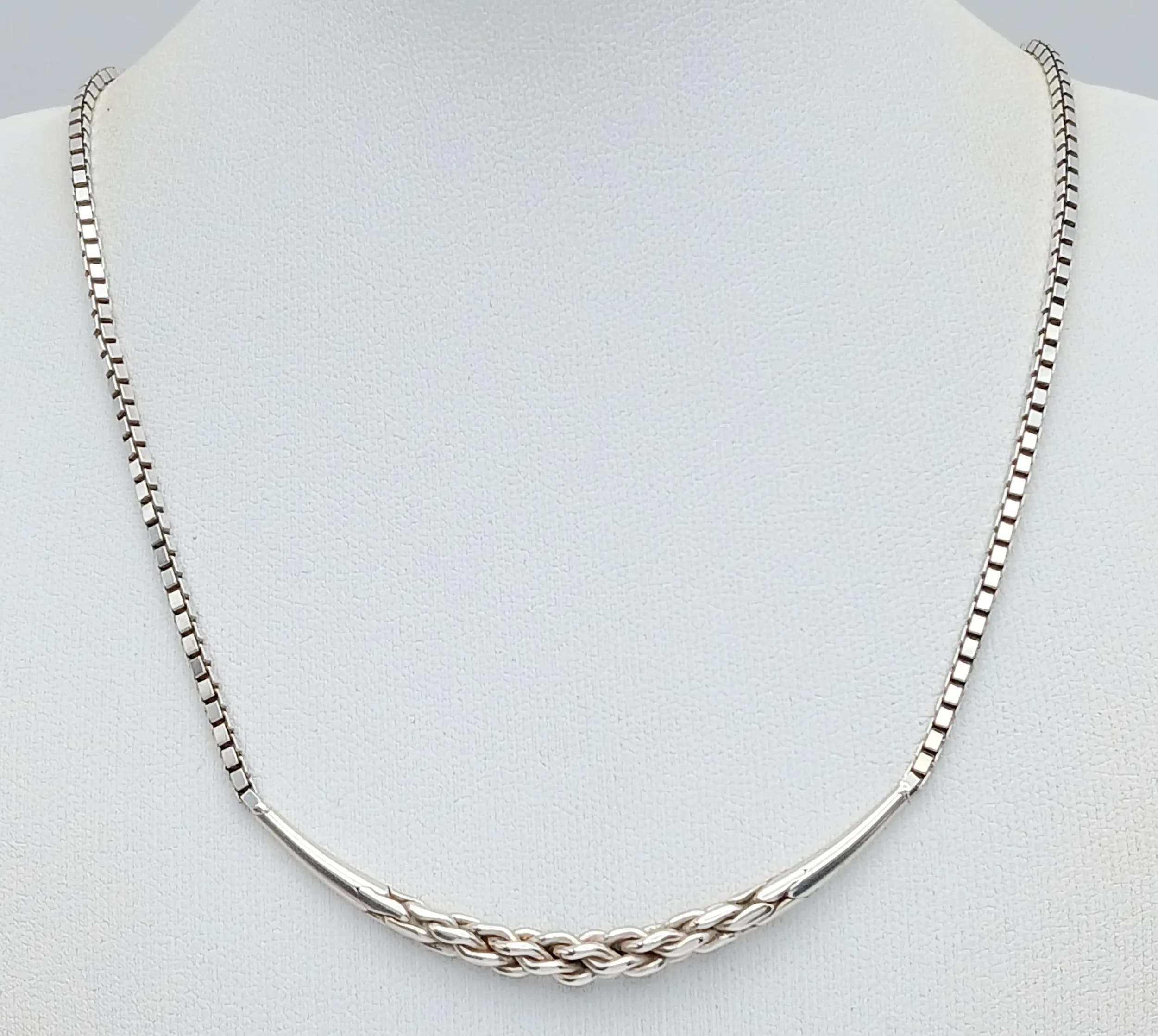 An Elegant Sterling Silver Bar Pendant Necklace. Featuring a fine box link chain with a curved bar pendant and central woven silver detail. Chain approx 34cm length. Pendant approx 6cm length. Gross weight 11 grams.