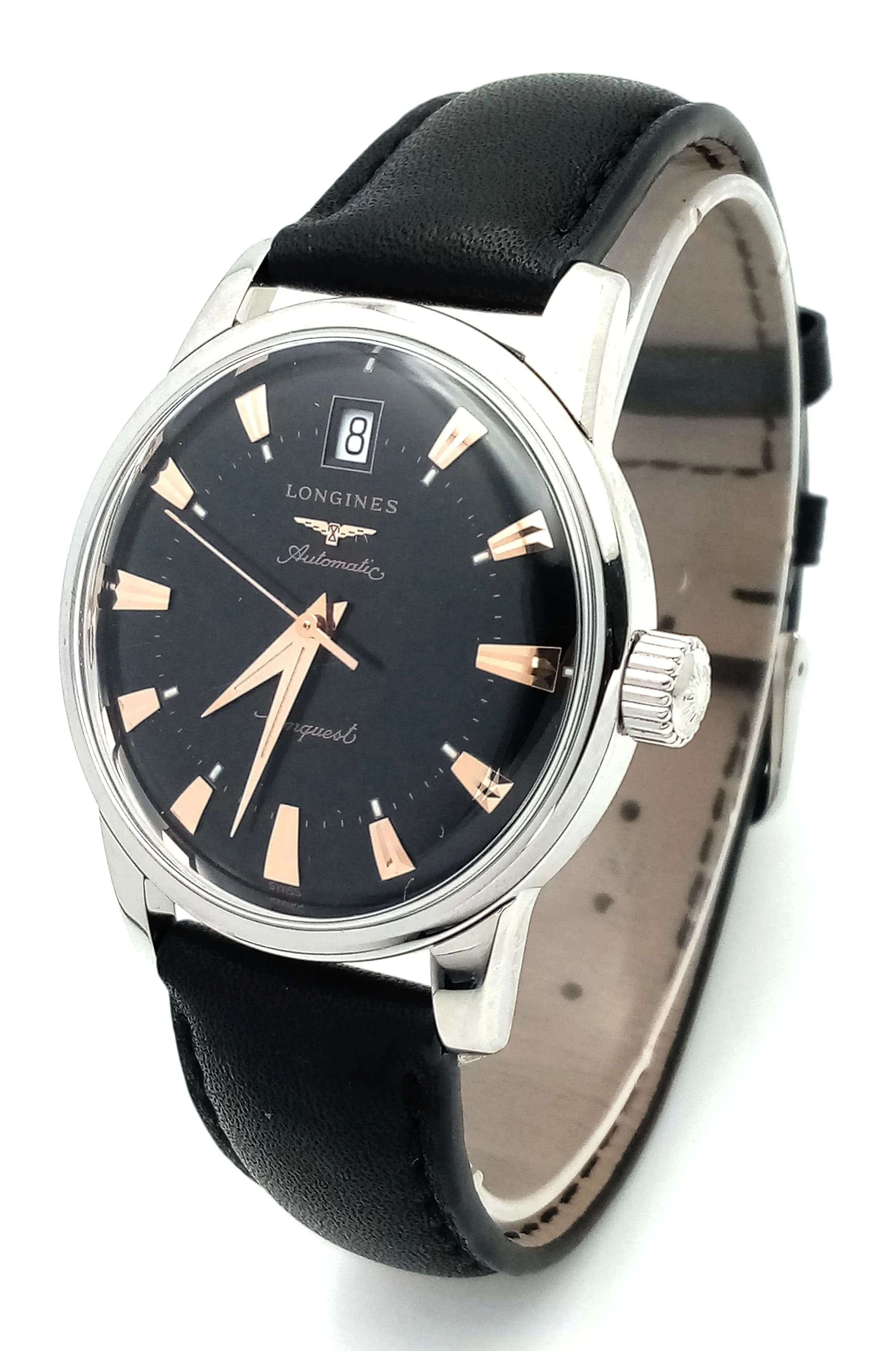 A Longines Conquest Heritage Automatic Gents Watch. This is a reissue design inspired by the original 1954 collection. Black leather strap. Stainless steel case - 35mm. Black dial with date window. Comes with a international warranty card. In good condition and working order.