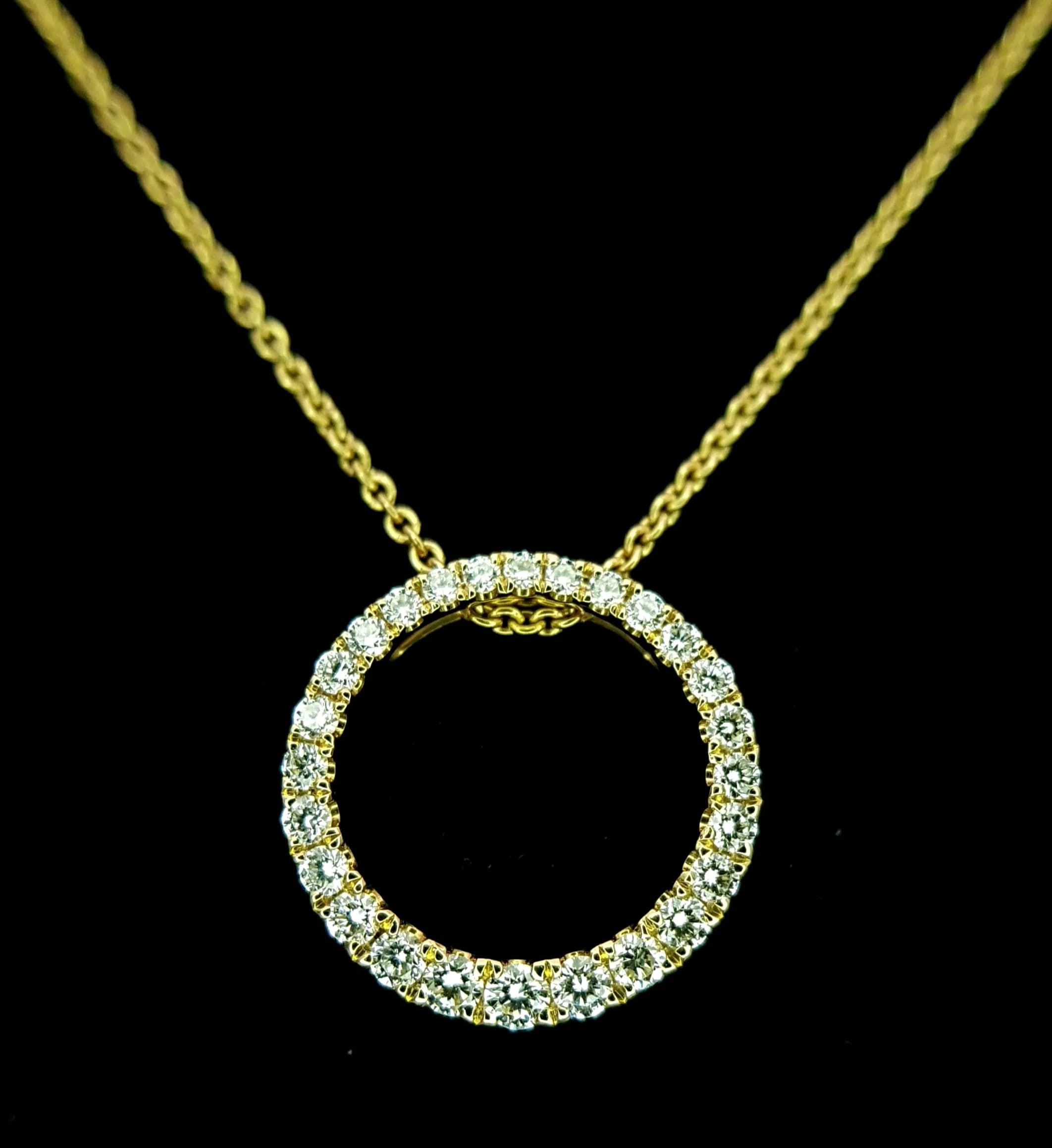 An 18K Yellow Gold Diamond Open Circular Pendant on an 18K Yellow gold Chain/Necklace with a 9K gold magnetic clasp. Round brilliant cut pave set diamonds having F-G colour with VS2 clarity. 15mm pendant and 46cm necklace. 5.05g. Ref: 027476.