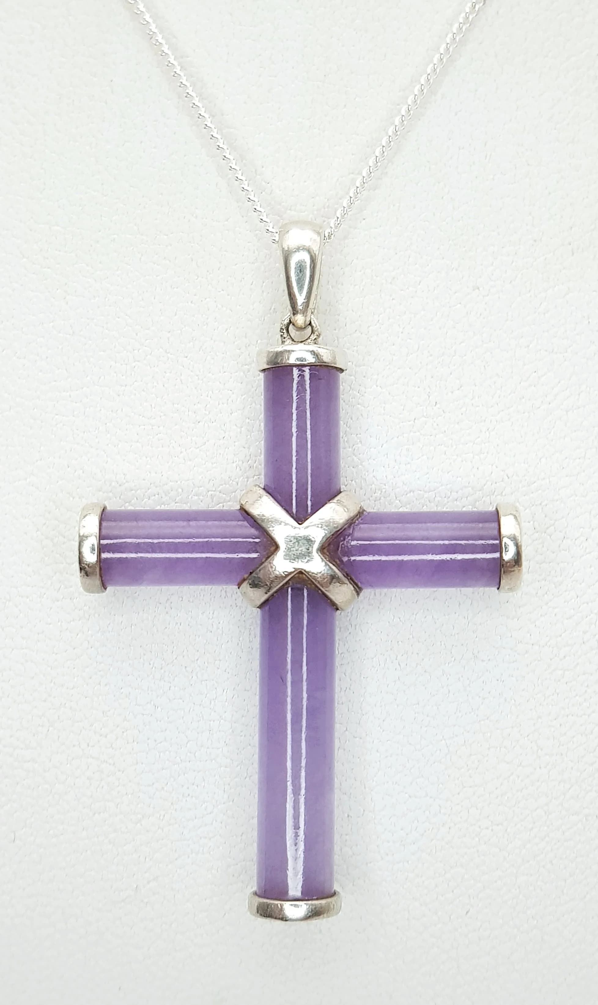A Pretty Sterling Silver and Lilac Amethyst Cross Pendant Necklace- 46cm Length Chain. The Cross measures 4.5cm drop and is 2.8cm Wide. The Necklace has a gross weight of 7.18 Grams.