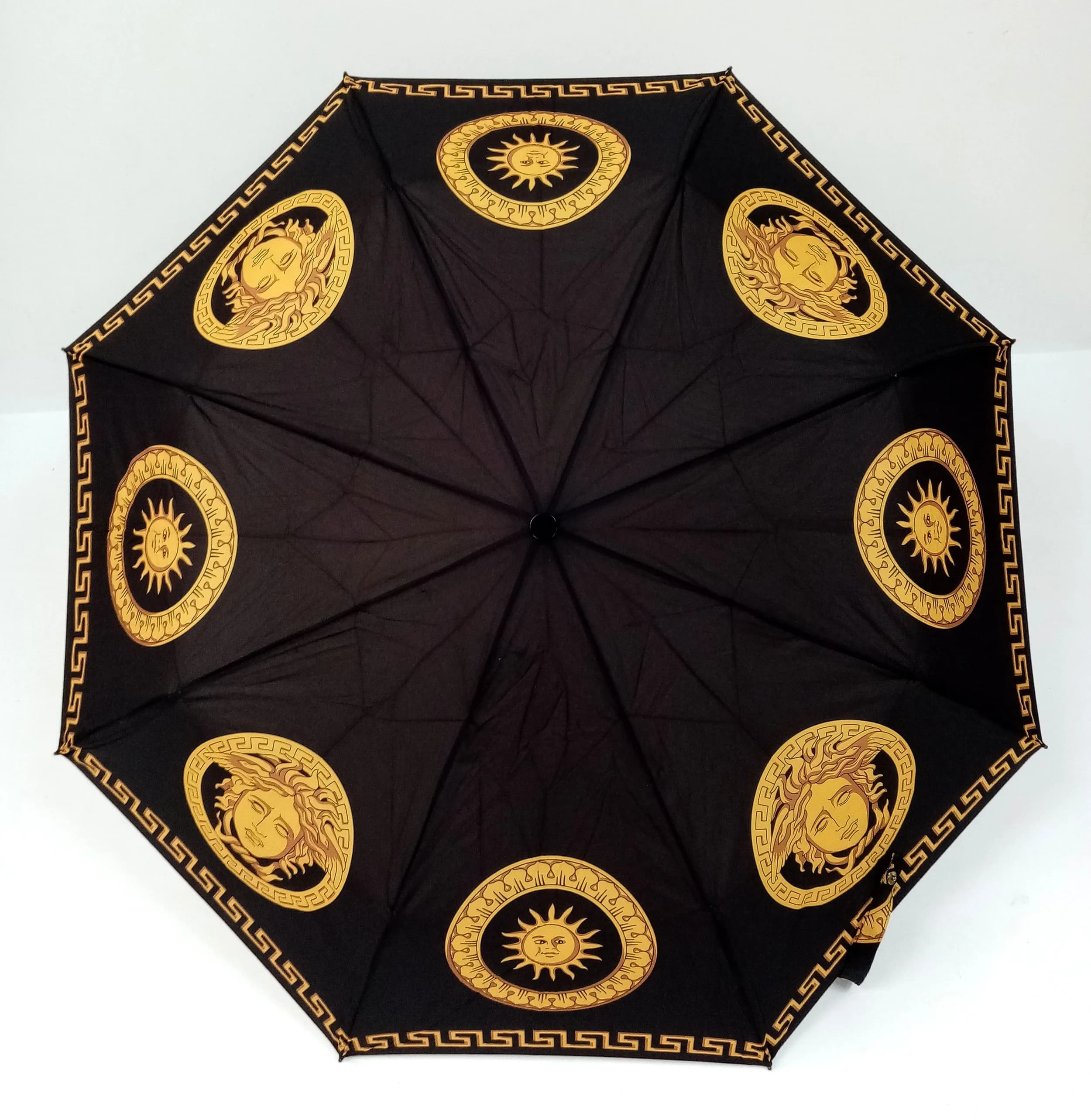 A Versace Branded Folding Umbrella with Gold-Tone Hardware and Medusa Motifs. Comes with a Carry Case. 24cm