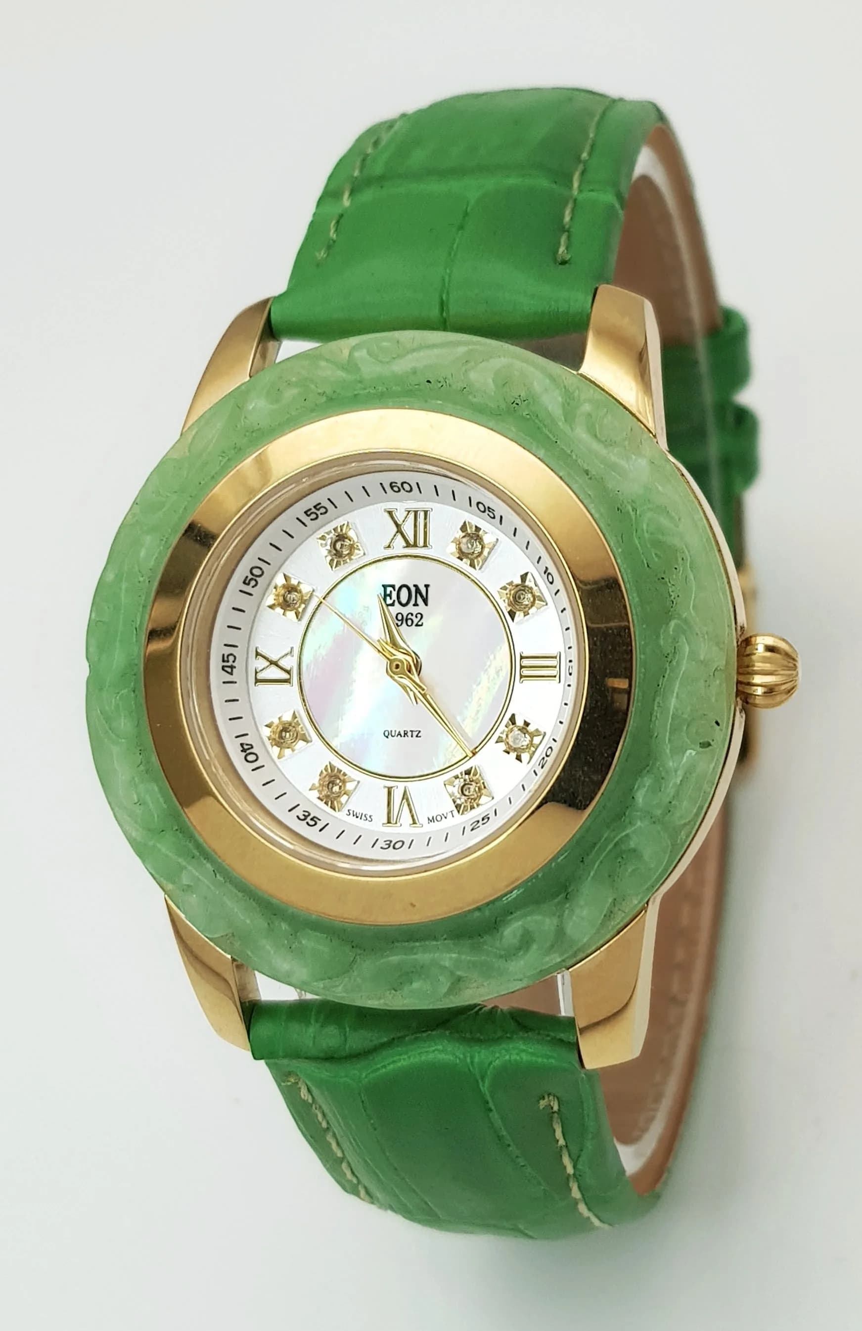 A Jade Bezel Eon Quartz Ladies Watch. Green leather strap. Gilded case - 34mm. Mother of pearl dial. In working order.