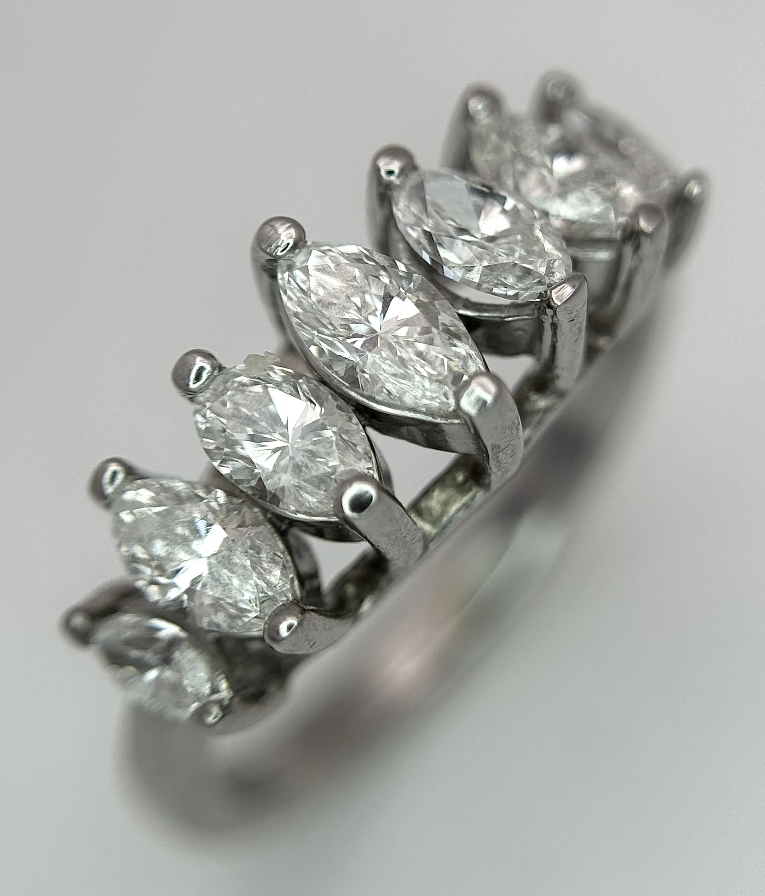 An 18K White Gold Marquise Cut Seven Stone Diamond Ring. Circa 1ctw diamonds. Ring size M. 5.58g total weight. Ref: 75007