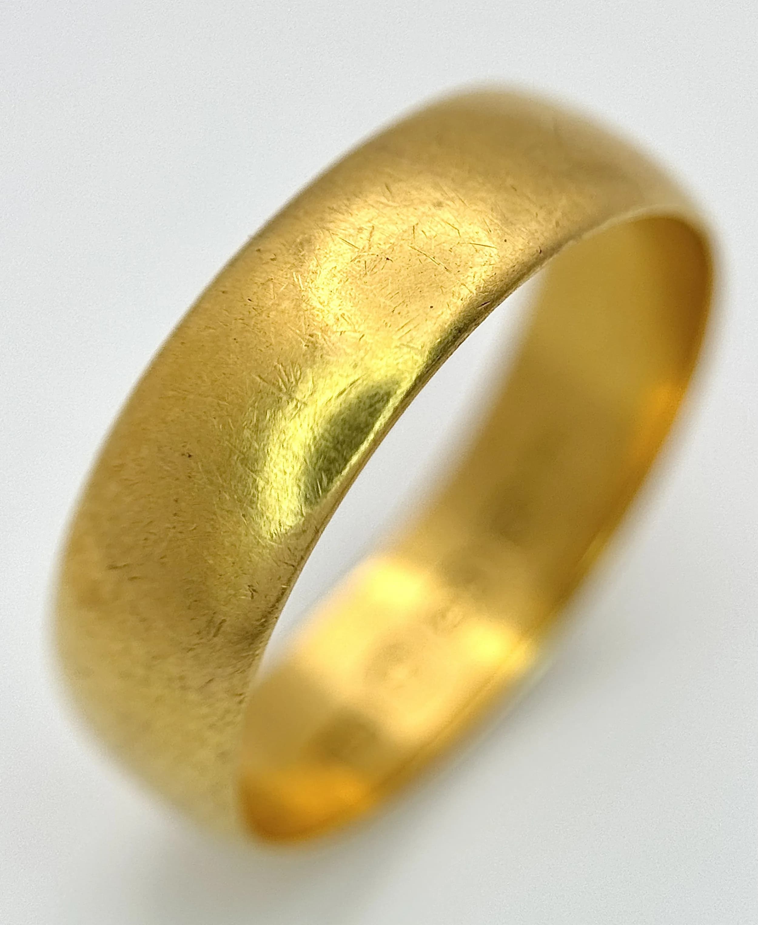 A 22K Yellow Gold Wedding Band. 5.7mm Band Width, Size P/Q. Total Weight 4.41 Grams.