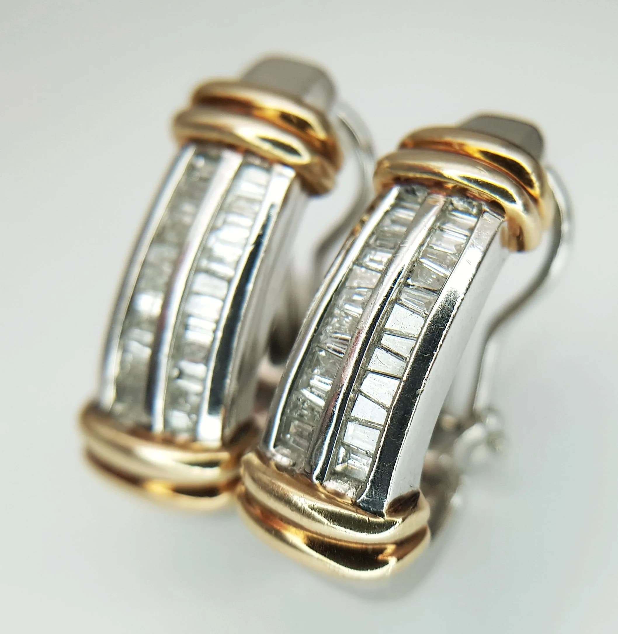 A PAIR OF 9K WHITE GOLD, WITH YELLOW GOLD ACCENTS, BAGUETTE CUT, DIAMOND SET EARRINGS. 0.60CTW. 13.4G. TAN 5001