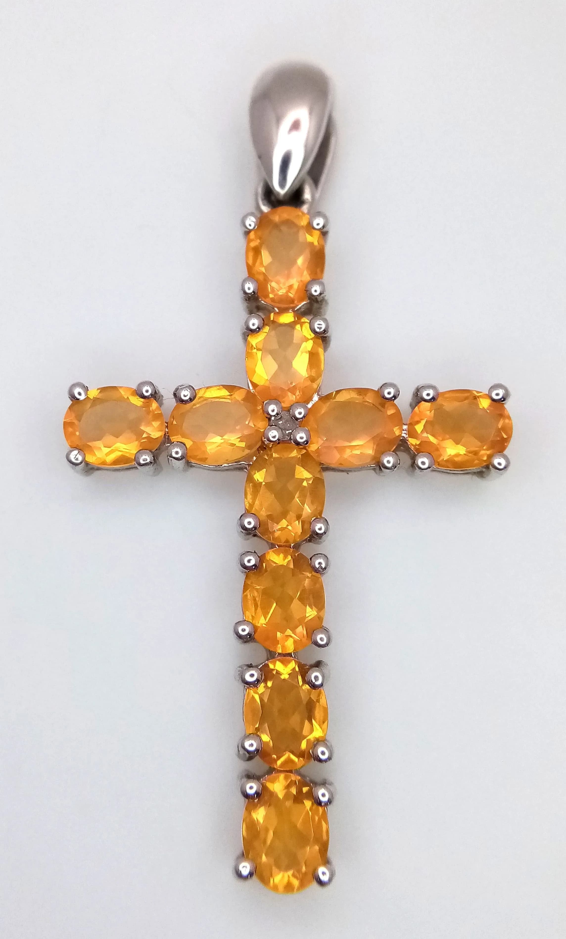 A Pretty Sterling Silver and Citrine Set Cross Pendant, The Cross measures 4cm Length and is set with Ten 5 x 4mm Oval Cut Citrine, approximately 3 carat total. The Necklace has a gross weight of 3.37 grams