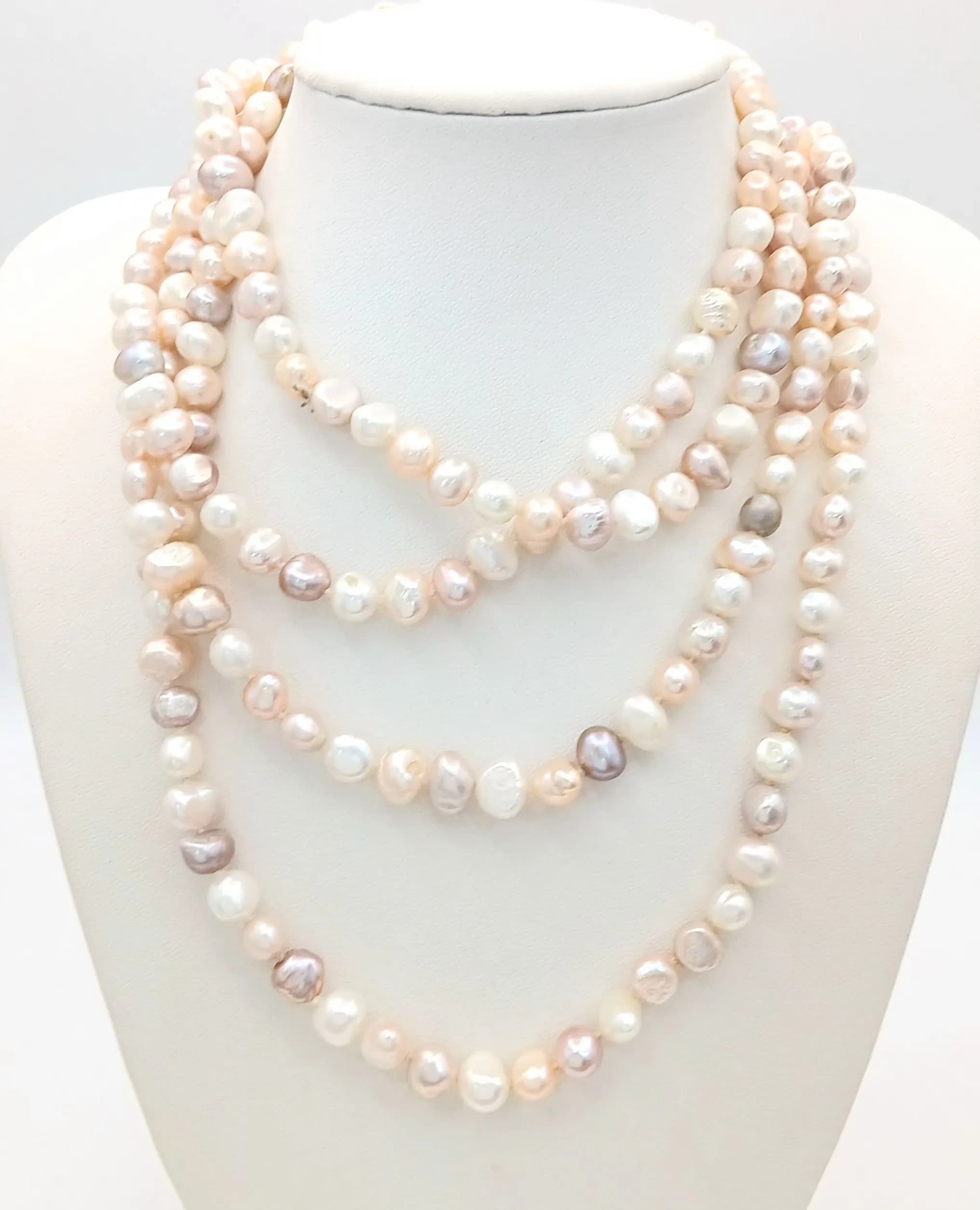 A pretty rope length Multicolour Freshwater Pearl Necklace. Comprising white, cream and pale pink freshwater pearls of various sizes and irregular shapes. Approx 160cm in length. Please see photos for details.