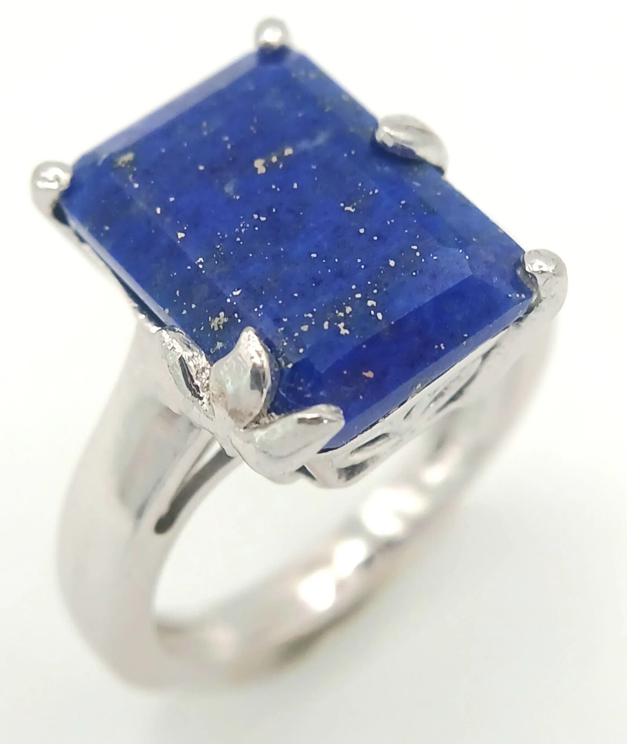 A Stylish Platinum Bonded Lapis Lazuli Set Ring. Size O1/2. The Ring is set with a 14 x 10mm Rectangle Cut Lapis Lazuli and has a gross weight of 5.24 grams.