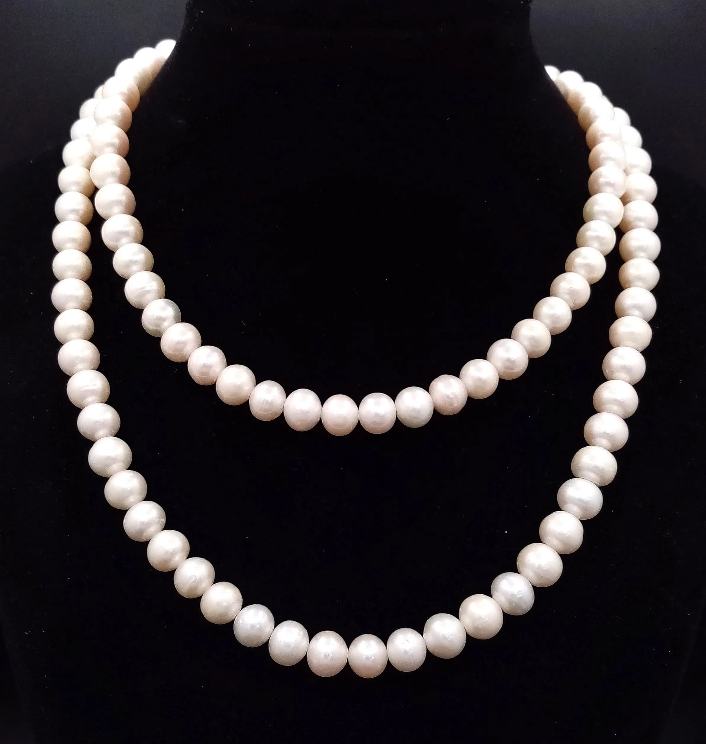 A classic matinee length Freshwater Pearl Necklace. Approx 80cm in length, strung with cream freshwater pearls and fitted with a 14/20 gold filled peanut box clasp. Please see photos for details.