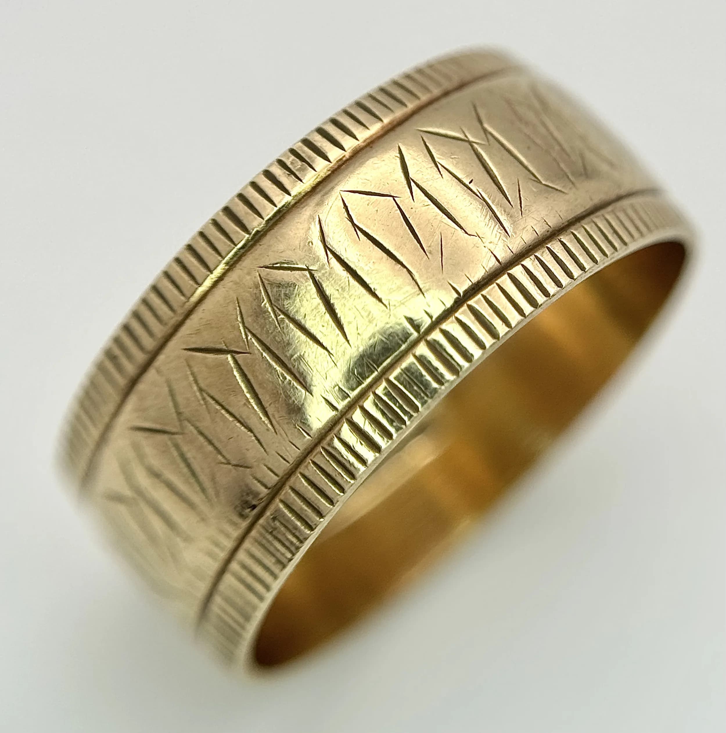 A 9K Yellow Gold Decorative Band Ring. 9mm width. Size S. 4.85g.