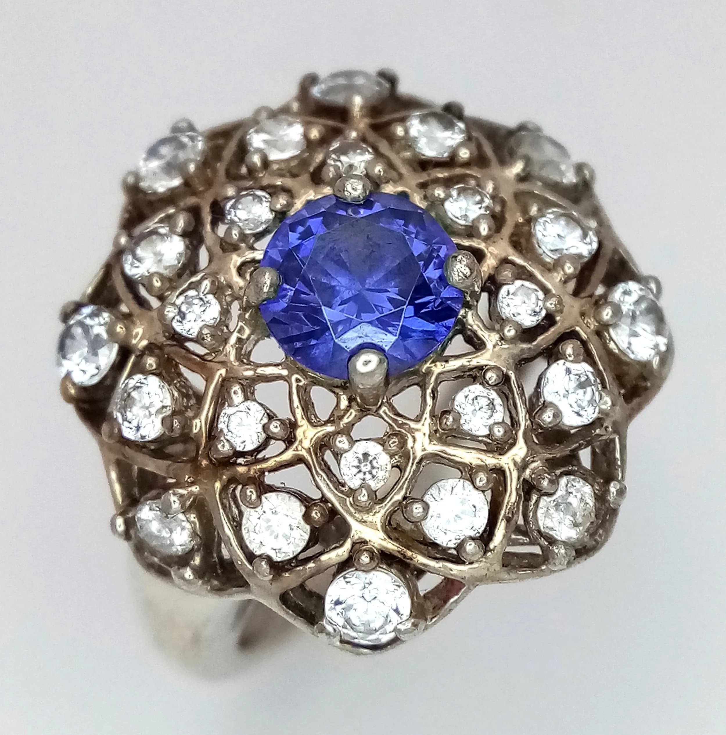 A Vintage Blue and White Stone Dress Ring. Size L. The Ring measures 2cm Diameter at the Crown and has a gross weight of 4.71 Grams