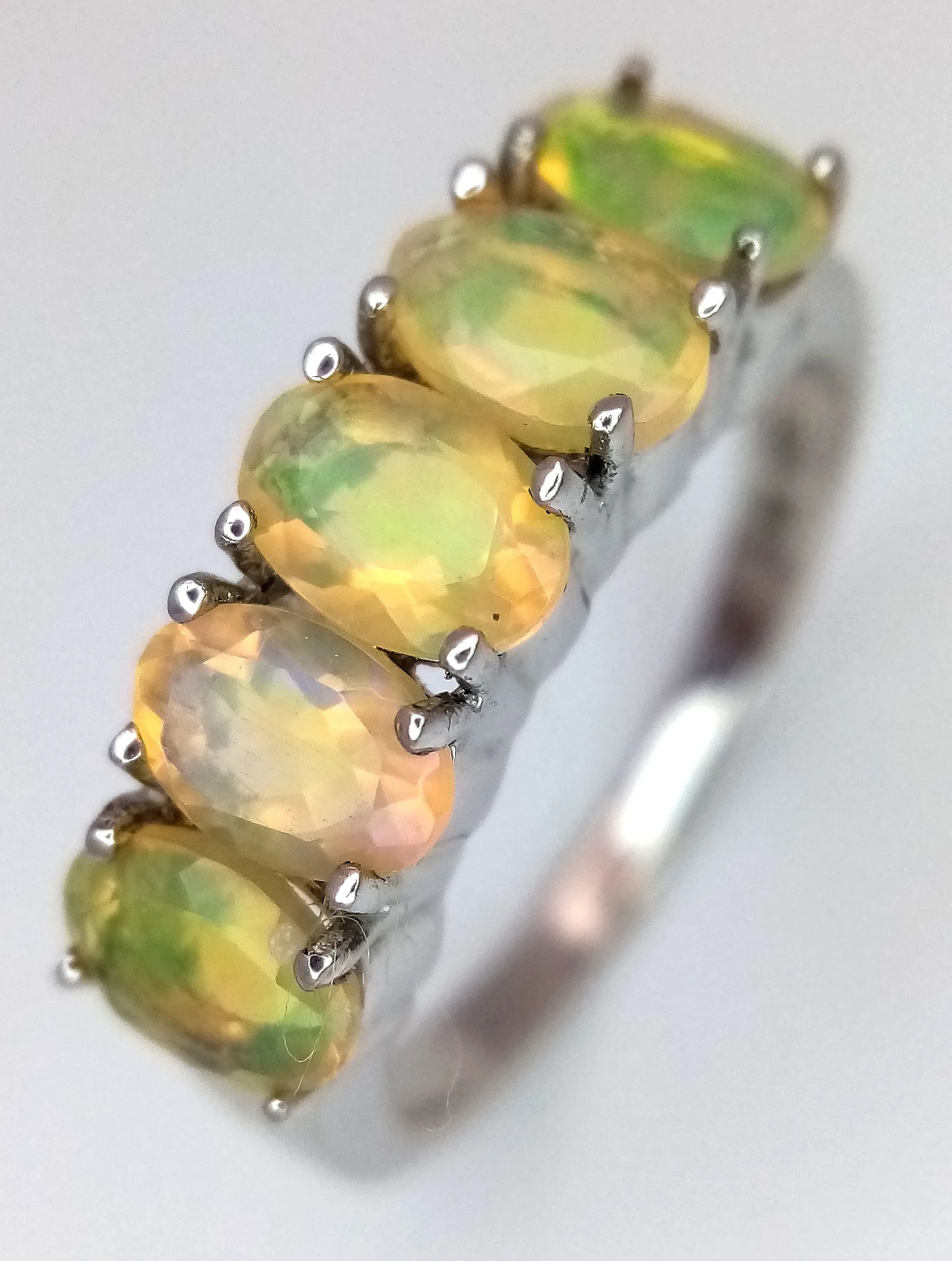 A Sterling Silver Ethiopian Opal Ring. Size P1/2. The Ring is set with fiery oval cut 6 x 4mm Opals, approximately 2.5 carat total. The Ring weighs 3.13 grams.