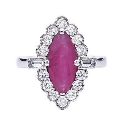A Platinum Marquise Cut Ruby and Diamond Ring. Centre Ruby Weighing 1.74ct, surrounded by Diamonds Weighing Total 0.63ct. Total Ring Weight 6.41g, Size M. Ref: 020799