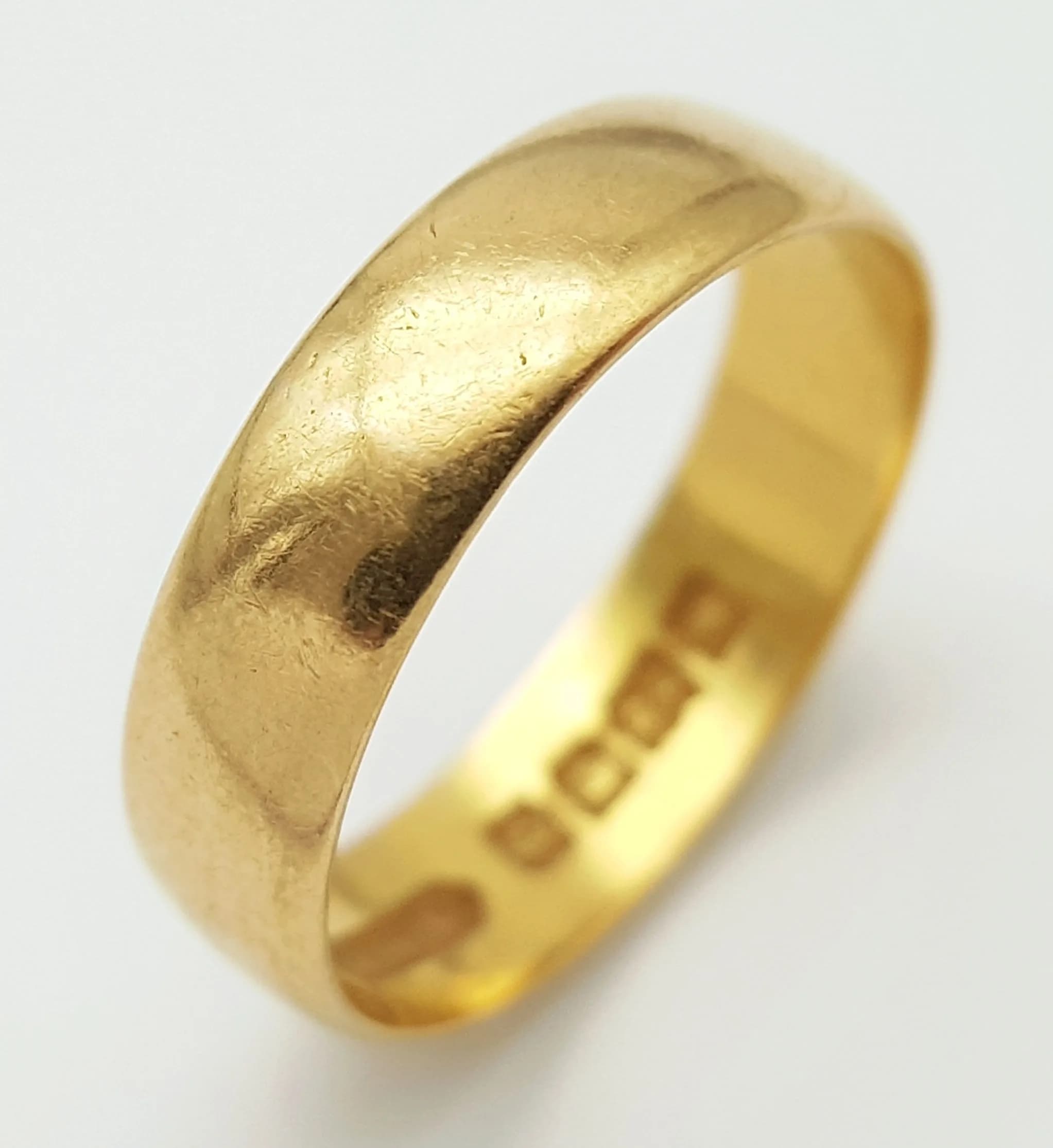 A 22K Yellow Gold Band Ring. 5mm width. Size J 1/2. UK hallmarks. 2.7g.