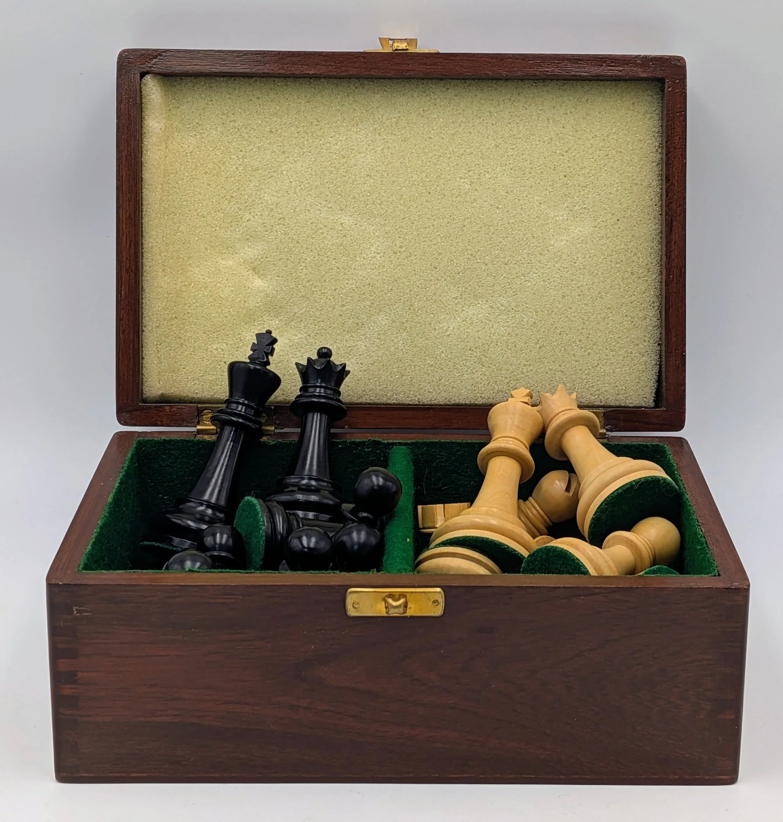 A Triple Weighted Ebony and Boxwood Chess Set. Comprising carved ebony and boxwood chess pieces, king approx 3.75" high, presented in a teak chest.